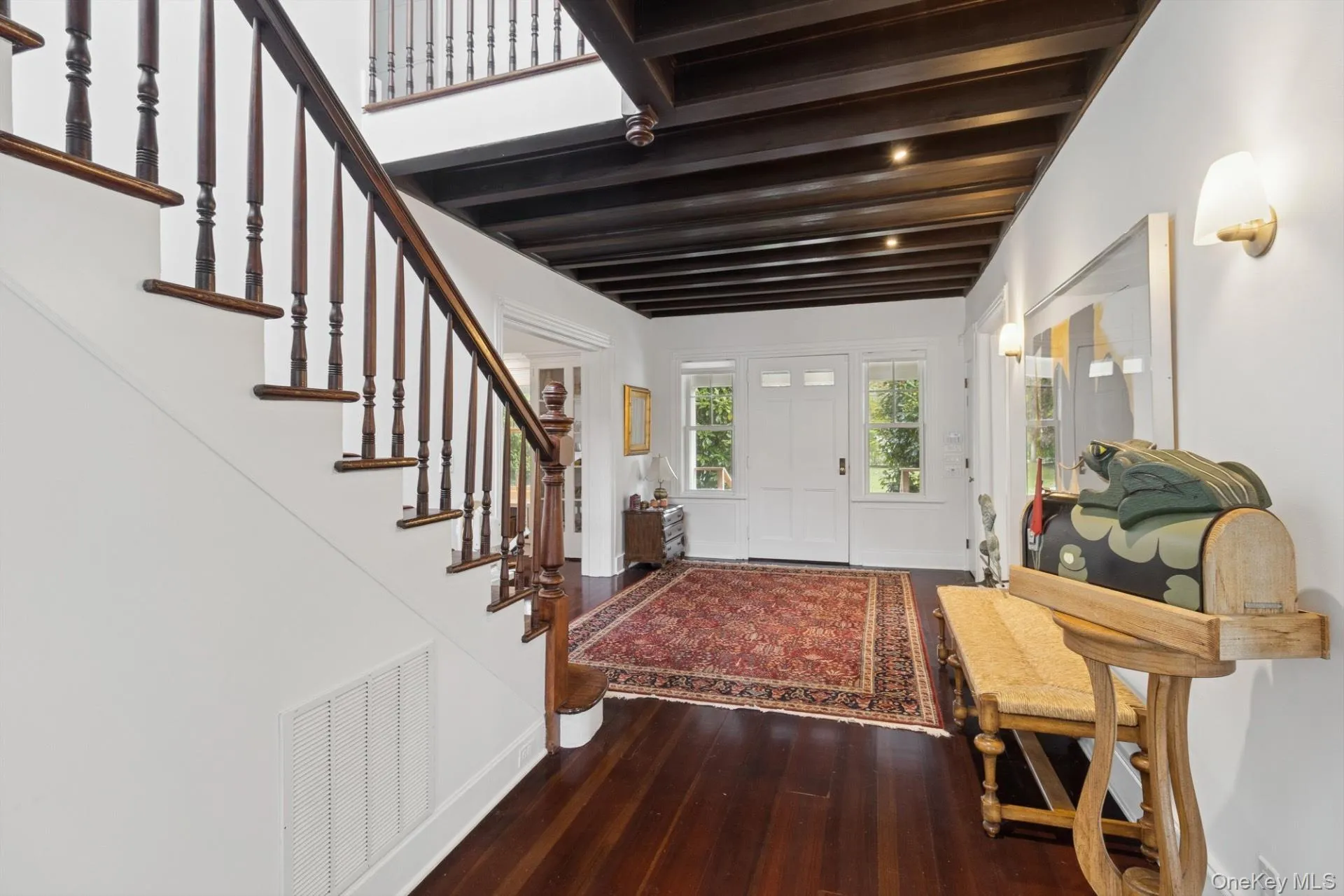 Entryway featuring dark wood-style floors and stairway Entryway featuring dark wood-style floors and stairway