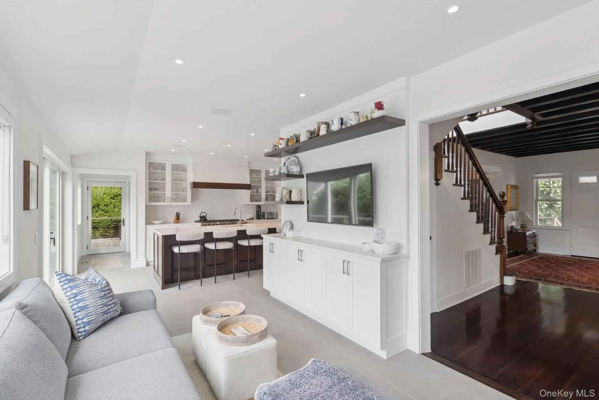 Living area with recessed lighting, stairs, light tile patterned floors, and lofted ceiling Living area with recessed lighting, stairs, light tile patterned floors, and lofted ceiling