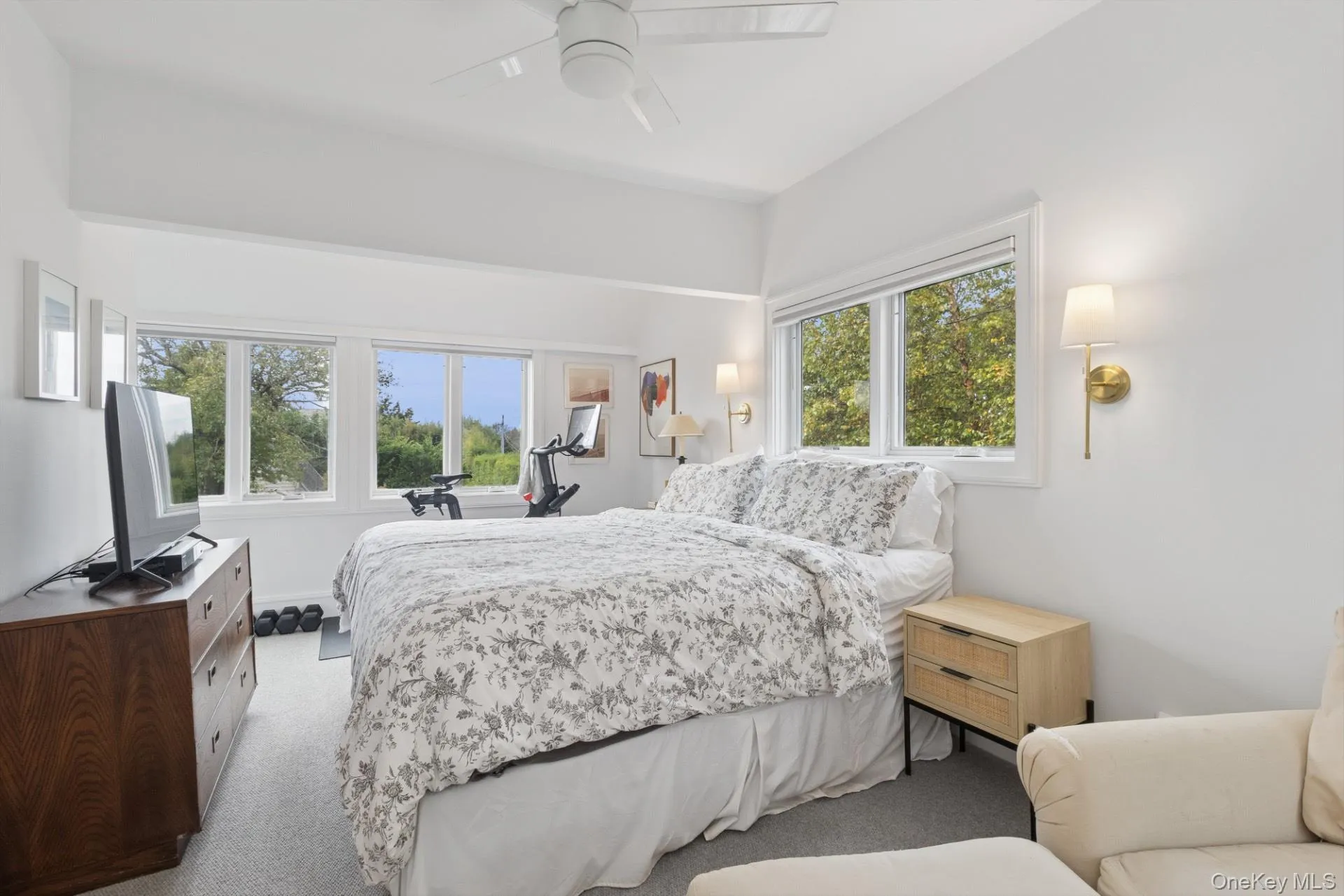 Bedroom featuring light colored carpet and ceiling fan Bedroom featuring light colored carpet and ceiling fan
