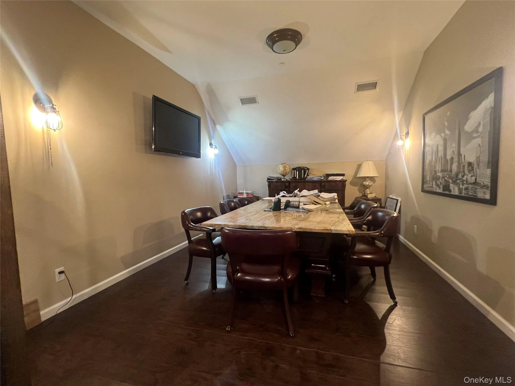Conference lofted ceiling and dark wood-style flooring Conference lofted ceiling and dark wood-style flooring