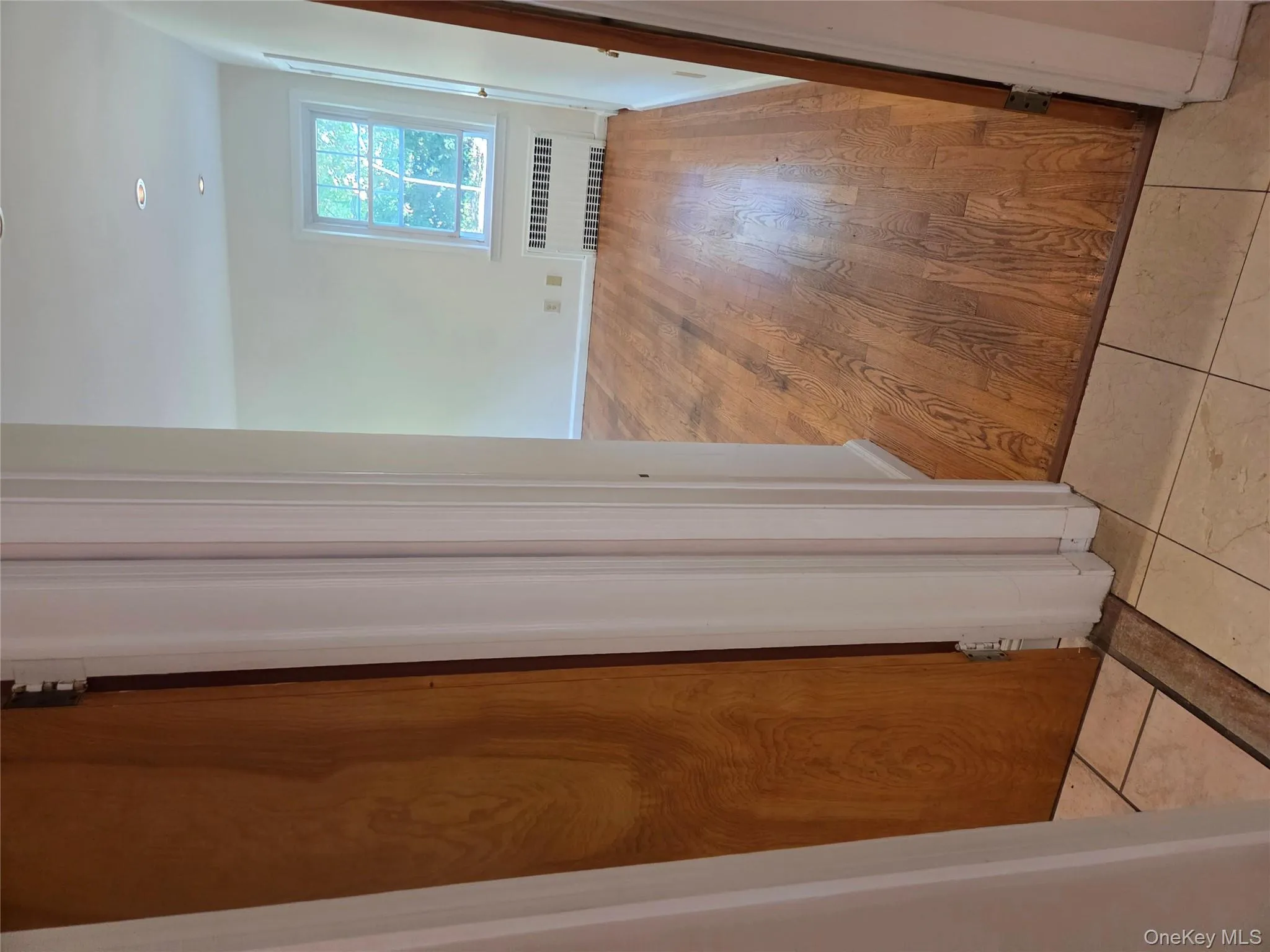 Corridor featuring radiator, light wood-type flooring, and recessed lighting Corridor featuring radiator, light wood-type flooring, and recessed lighting