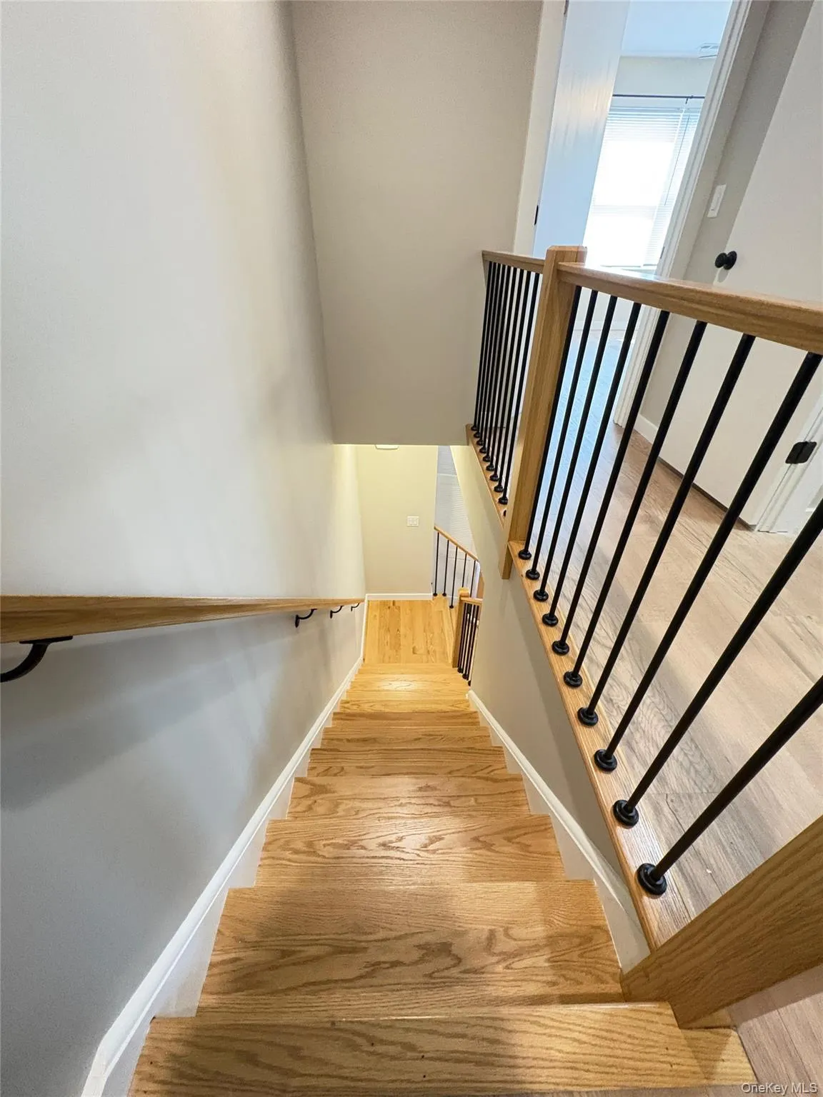 Stairway with wood finished floors and baseboards Stairway with wood finished floors and baseboards