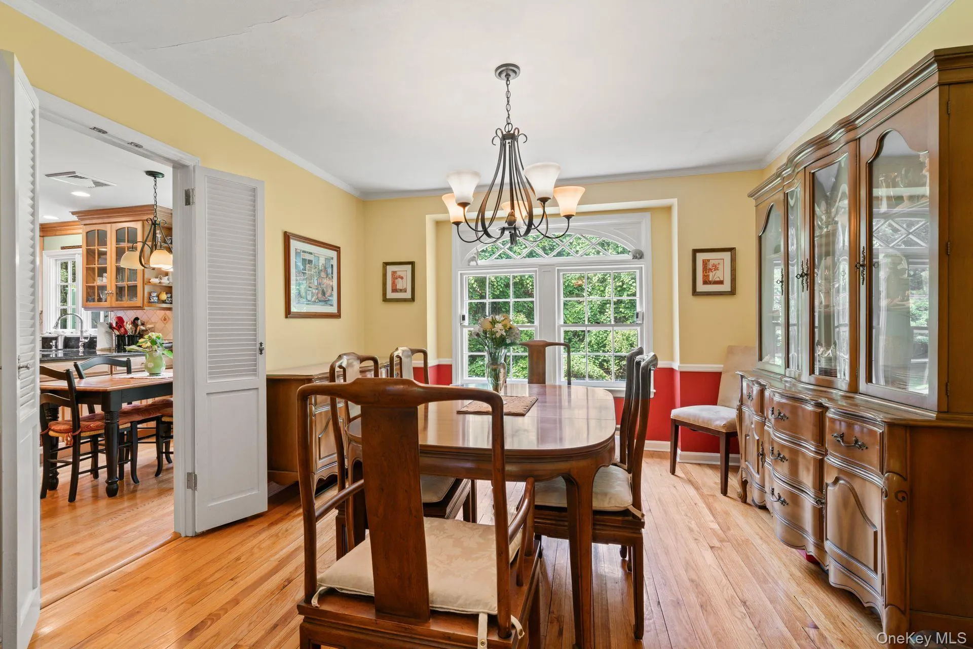 Dining room featuring ornamental molding, a chandelier, plenty of natural light, and light wood-type flooring Dining room featuring ornamental molding, a chandelier, plenty of natural light, and light wood-type flooring