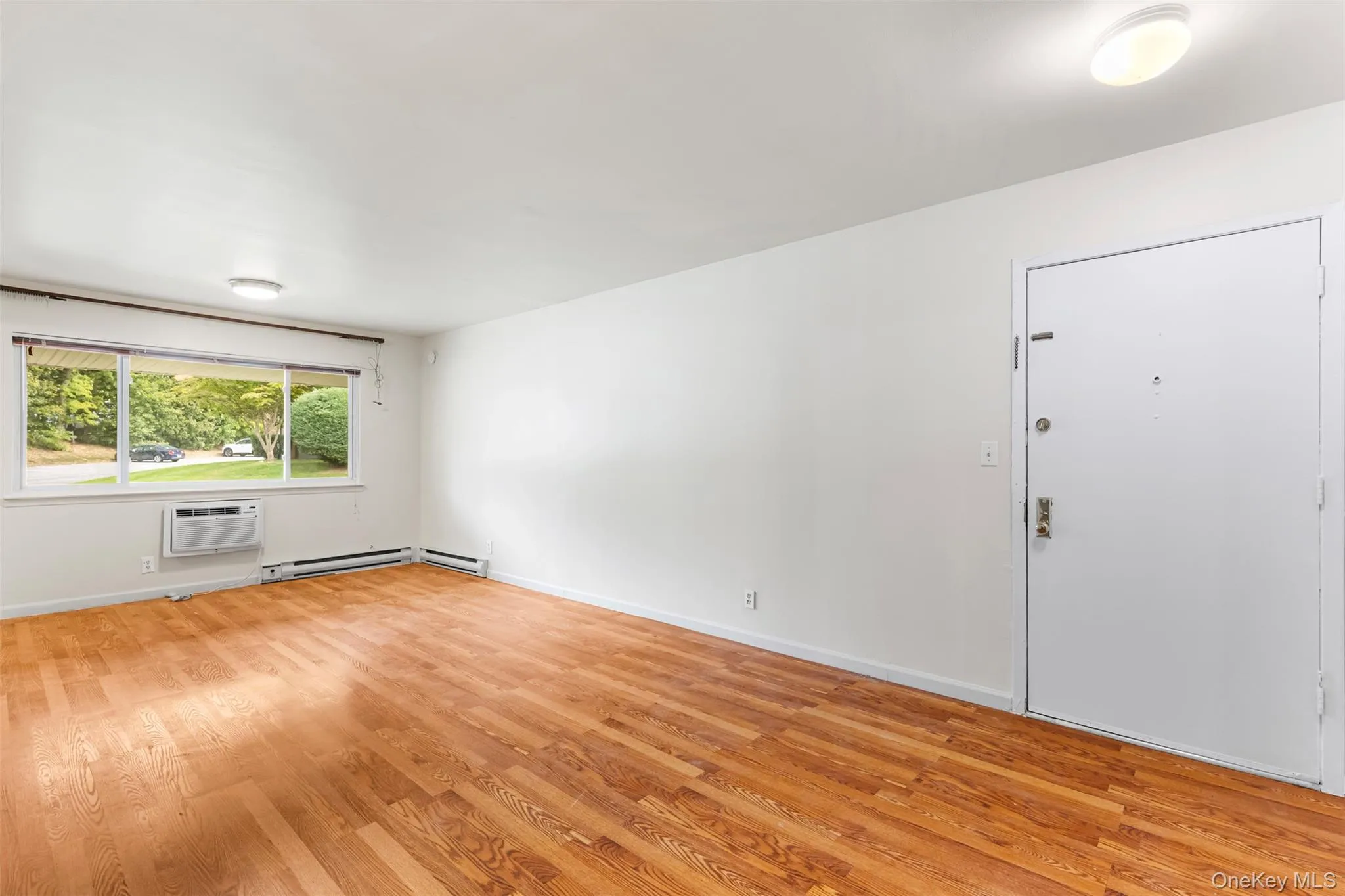 Empty room featuring light wood-type flooring and baseboards Empty room featuring light wood-type flooring and baseboards