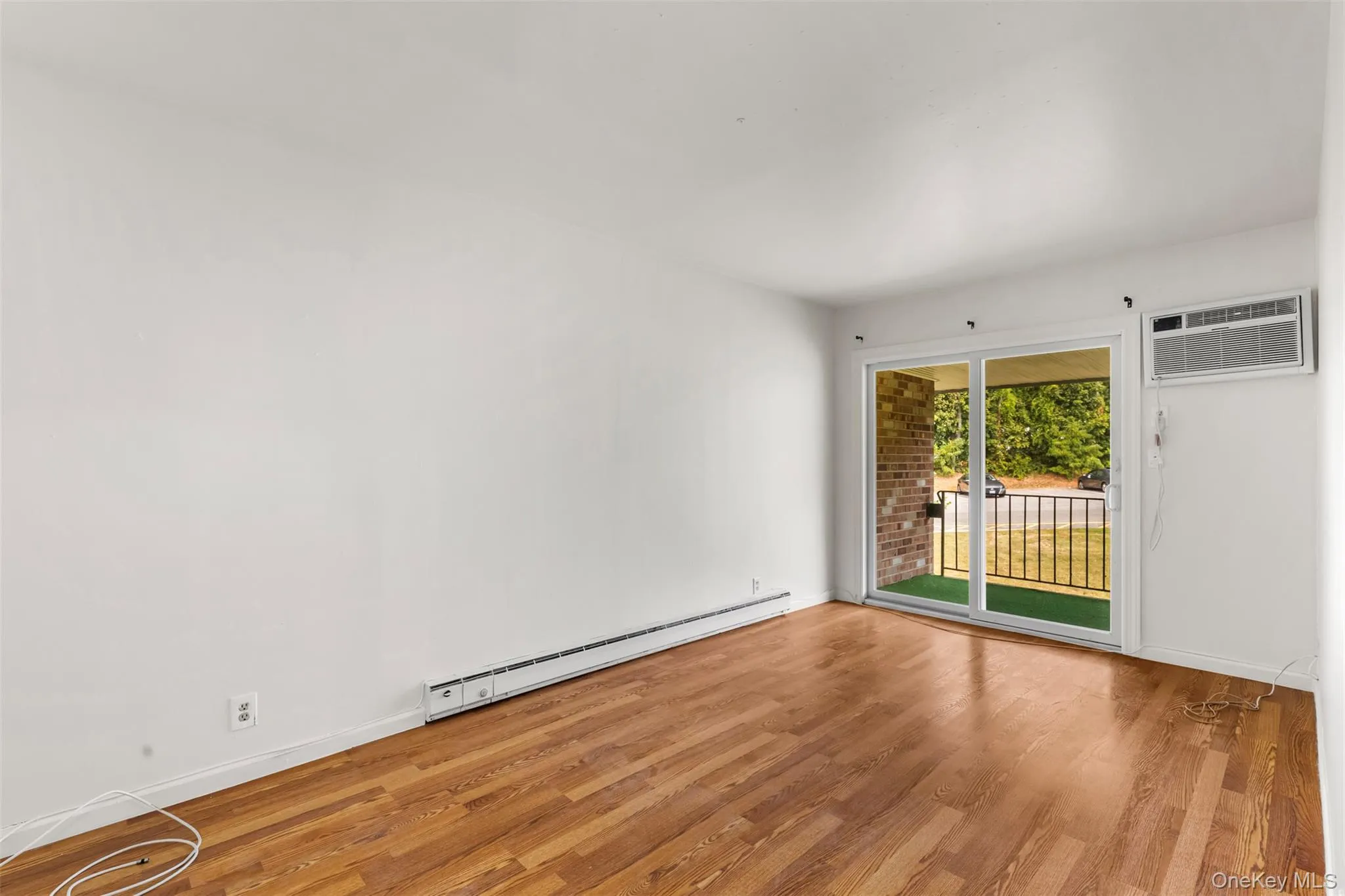 Primary bedroom with sliders to Balcony Primary bedroom with sliders to Balcony