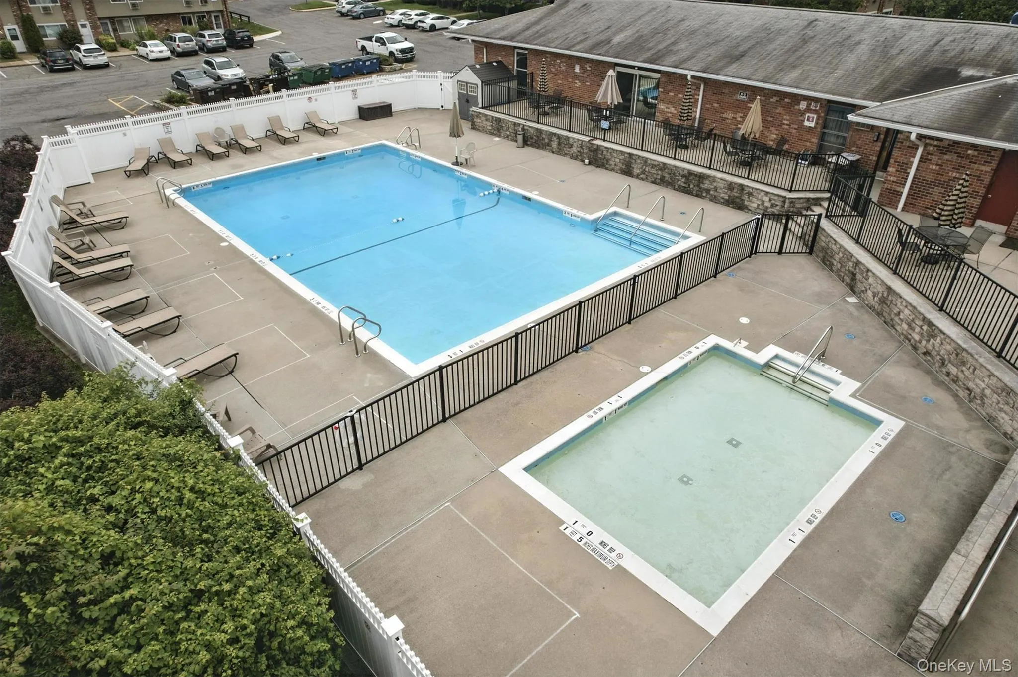 Community pool with a patio area Community pool with a patio area