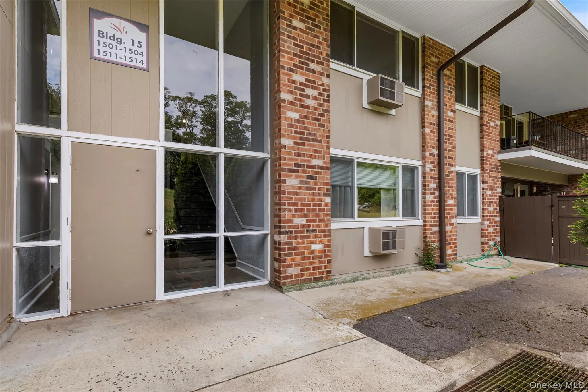 Doorway to property featuring brick siding Doorway to property featuring brick siding