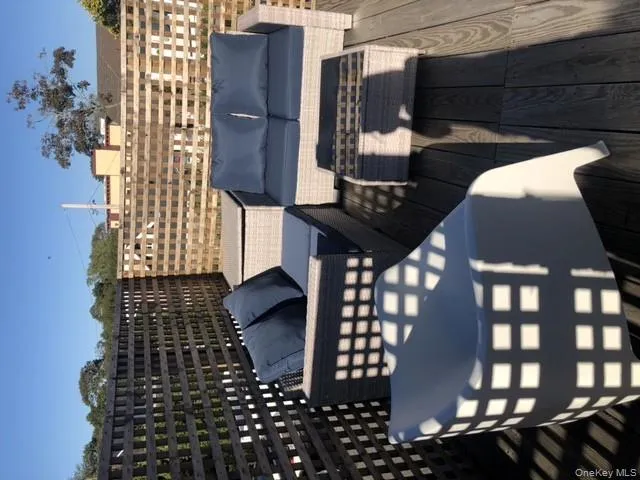 Wooden terrace featuring an outdoor hangout area Wooden terrace featuring an outdoor hangout area