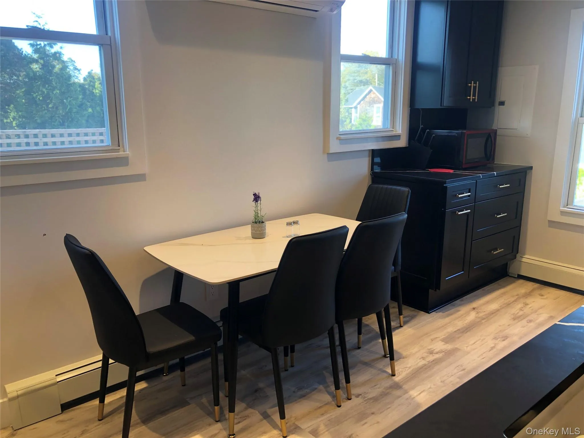 Dining space with light wood-style floors and baseboards Dining space with light wood-style floors and baseboards