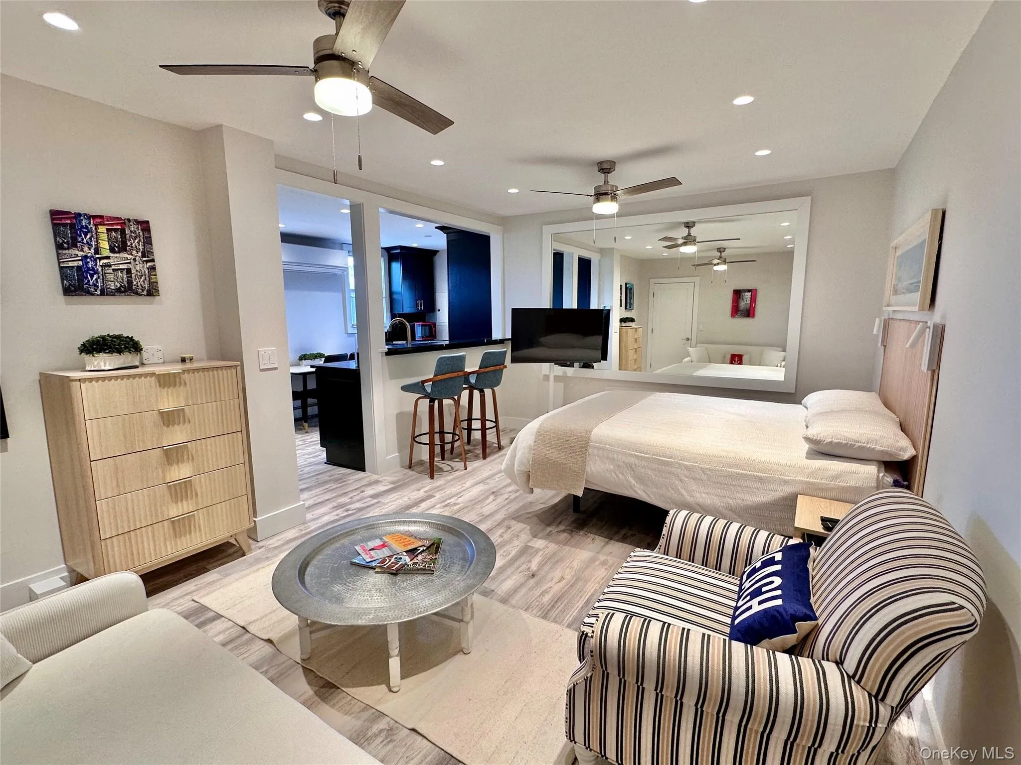 Bedroom featuring light wood-style flooring, recessed lighting, and a ceiling fan Bedroom featuring light wood-style flooring, recessed lighting, and a ceiling fan