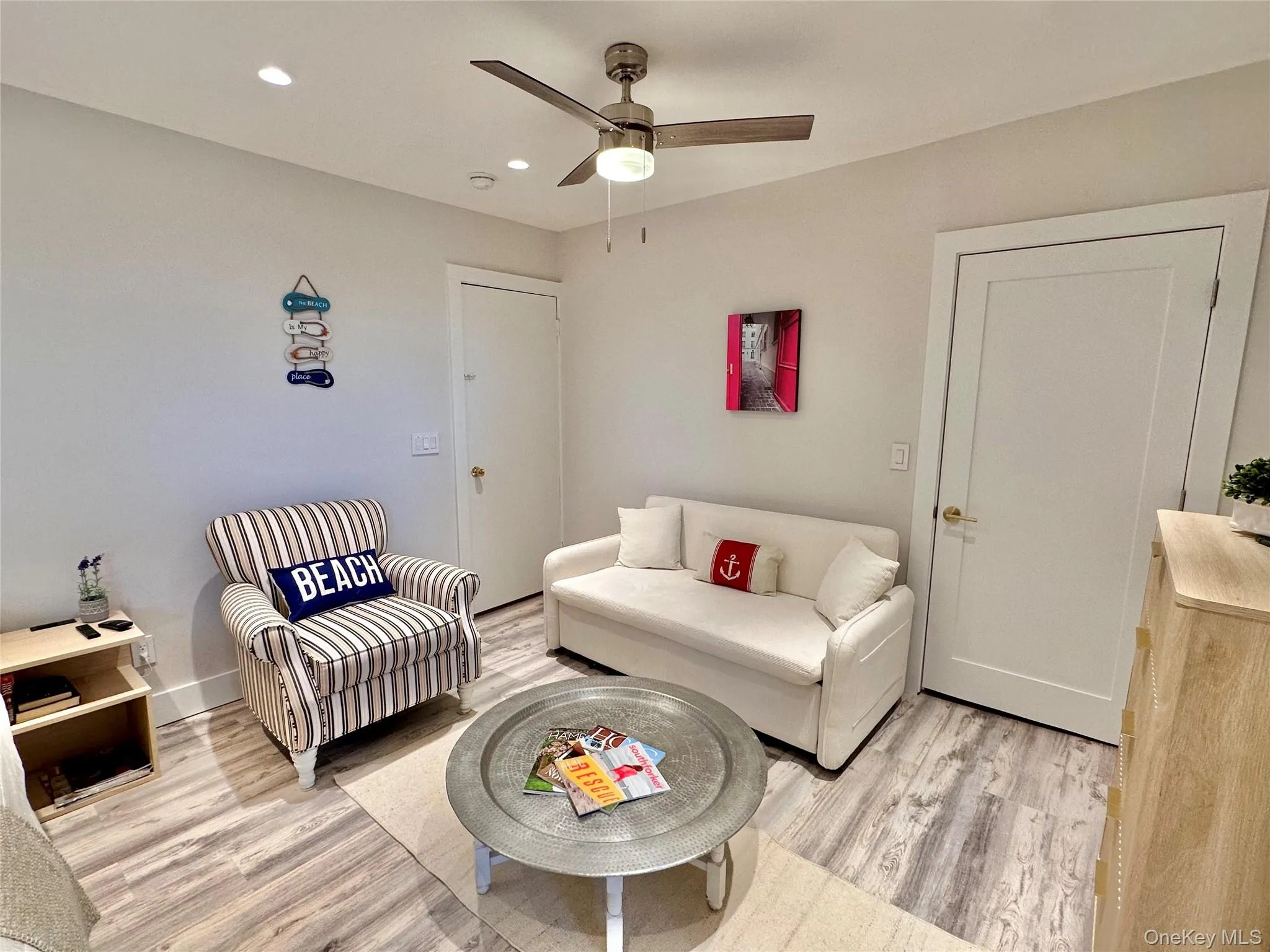 Living room with light wood-style flooring, recessed lighting, and ceiling fan Living room with light wood-style flooring, recessed lighting, and ceiling fan