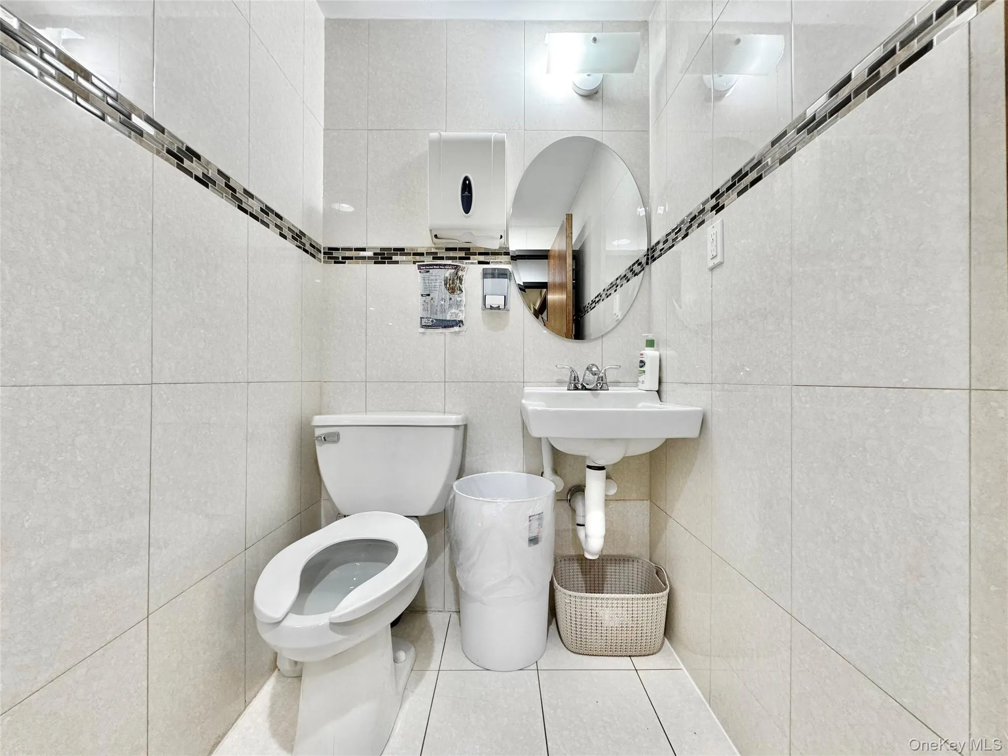 Bathroom with tile walls and tile patterned floors Bathroom with tile walls and tile patterned floors