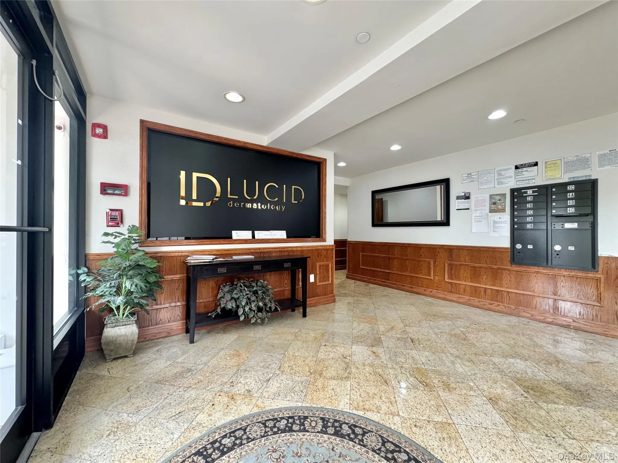 Welcome area with a wainscoted wall, recessed lighting, mail area, and wooden walls Welcome area with a wainscoted wall, recessed lighting, mail area, and wooden walls