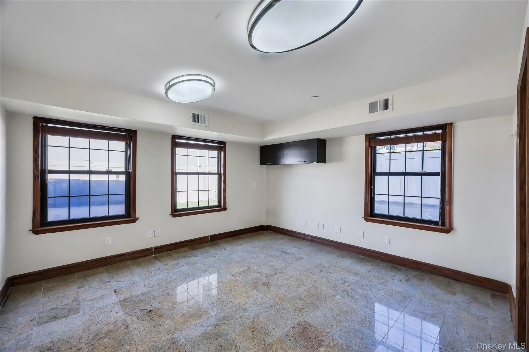 Spare room featuring granite floors Spare room featuring granite floors