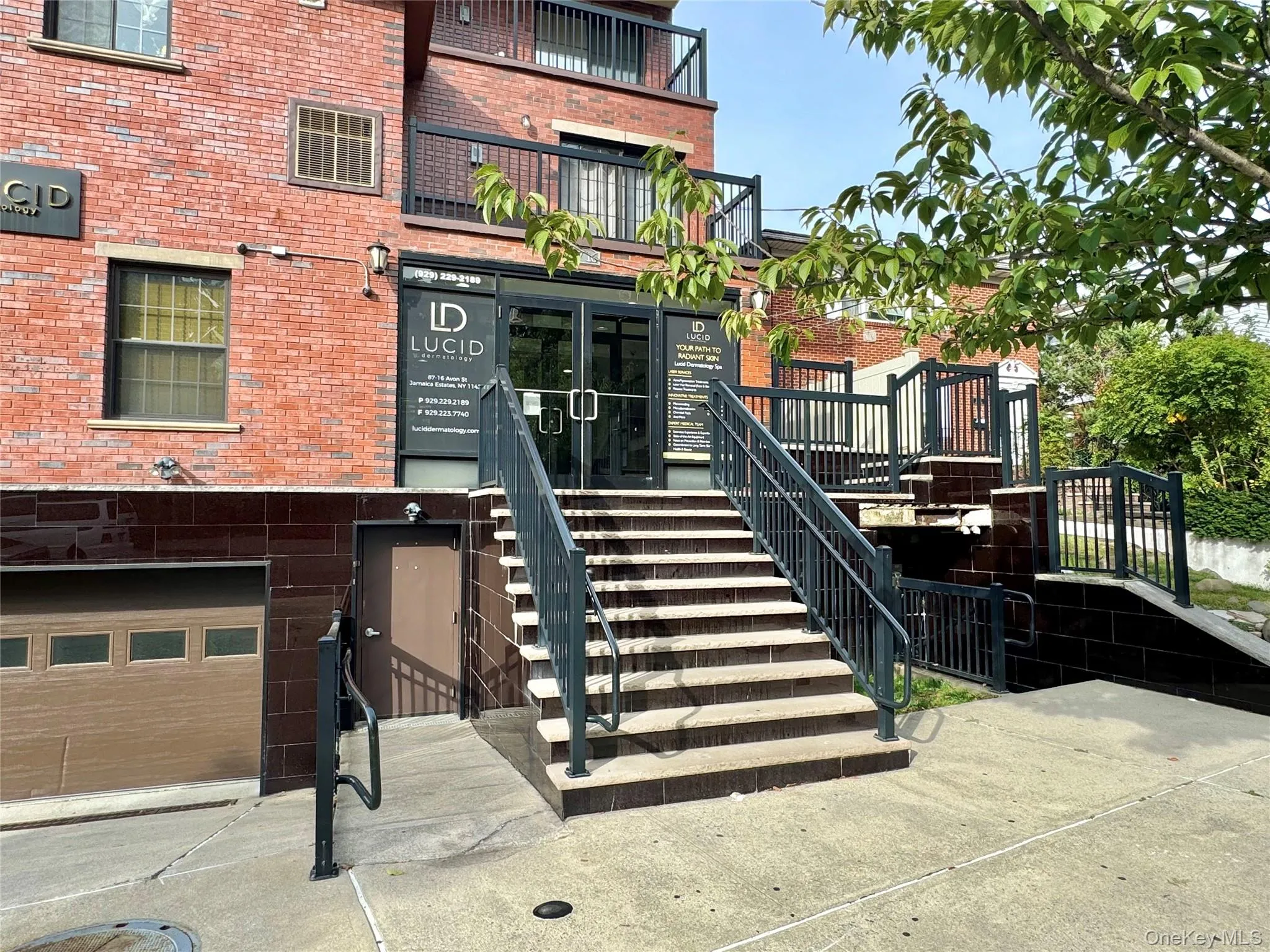 Doorway to property with brick siding and a garage Doorway to property with brick siding and a garage