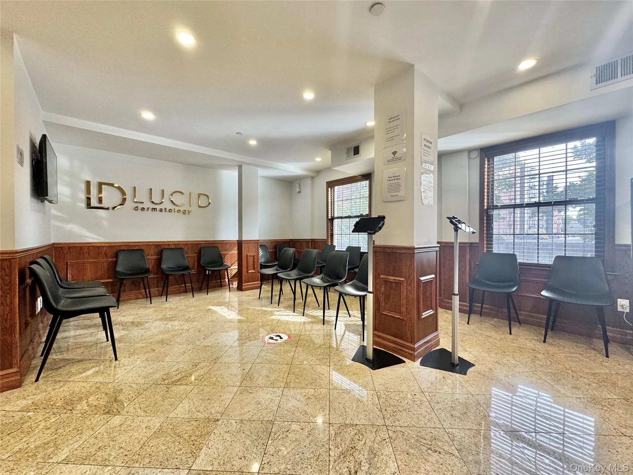 Welcome area with a wainscoted wall and recessed lighting Welcome area with a wainscoted wall and recessed lighting