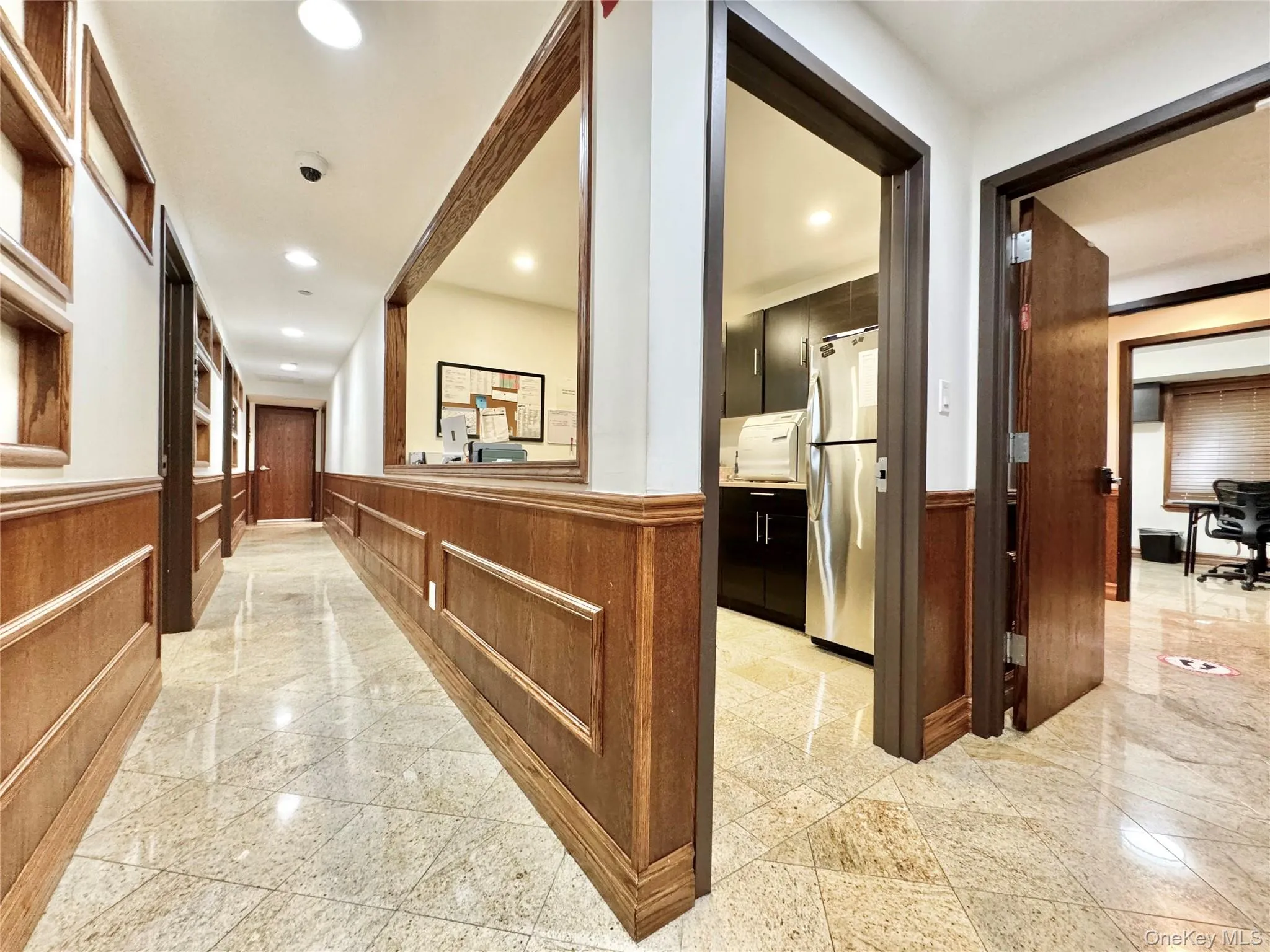 Corridor with wainscoting, a decorative wall, recessed lighting, granite tiled floors, and wood walls Corridor with wainscoting, a decorative wall, recessed lighting, granite tiled floors, and wood walls