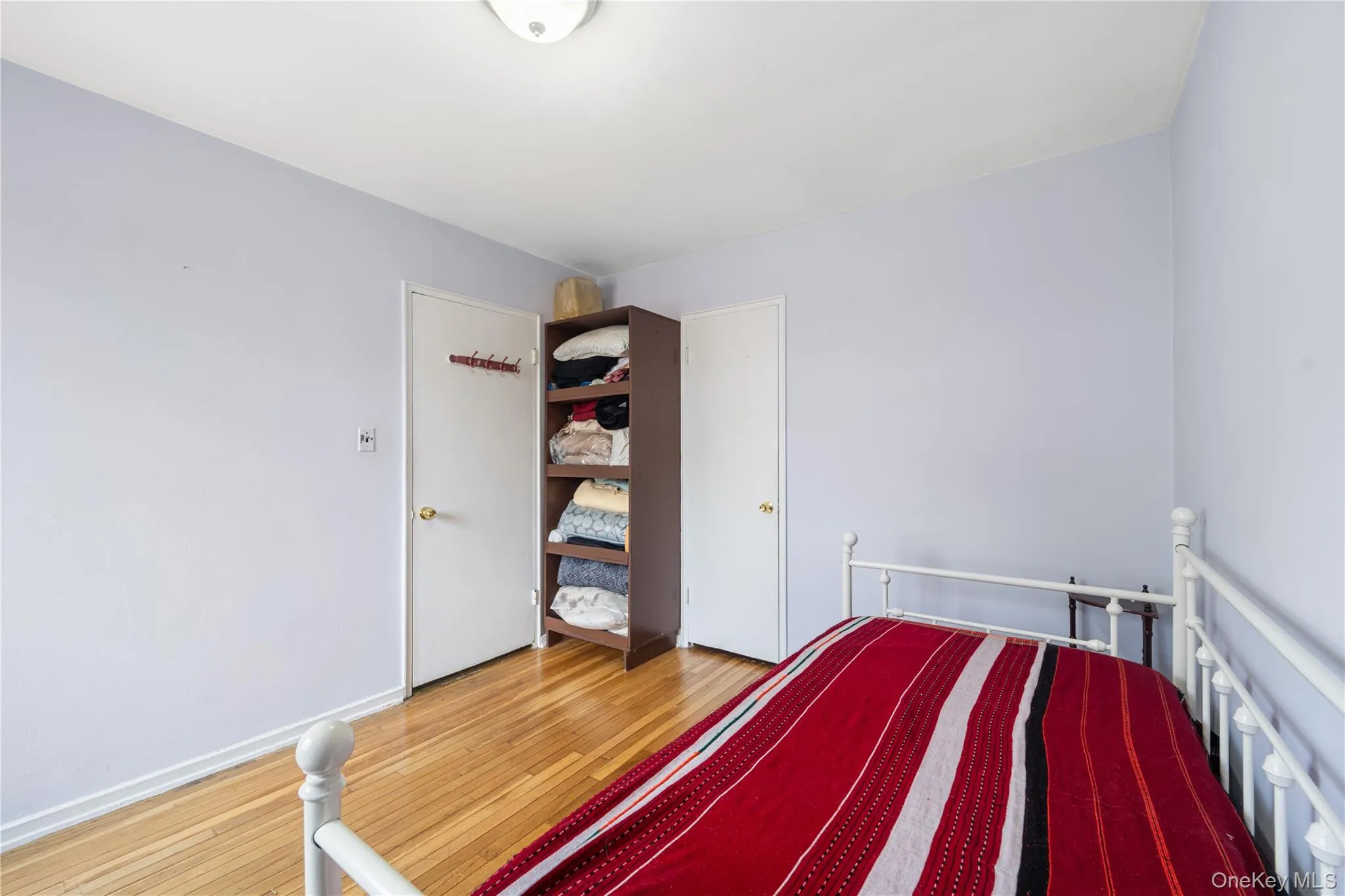 Unfurnished bedroom featuring light wood-style floors and baseboards Unfurnished bedroom featuring light wood-style floors and baseboards