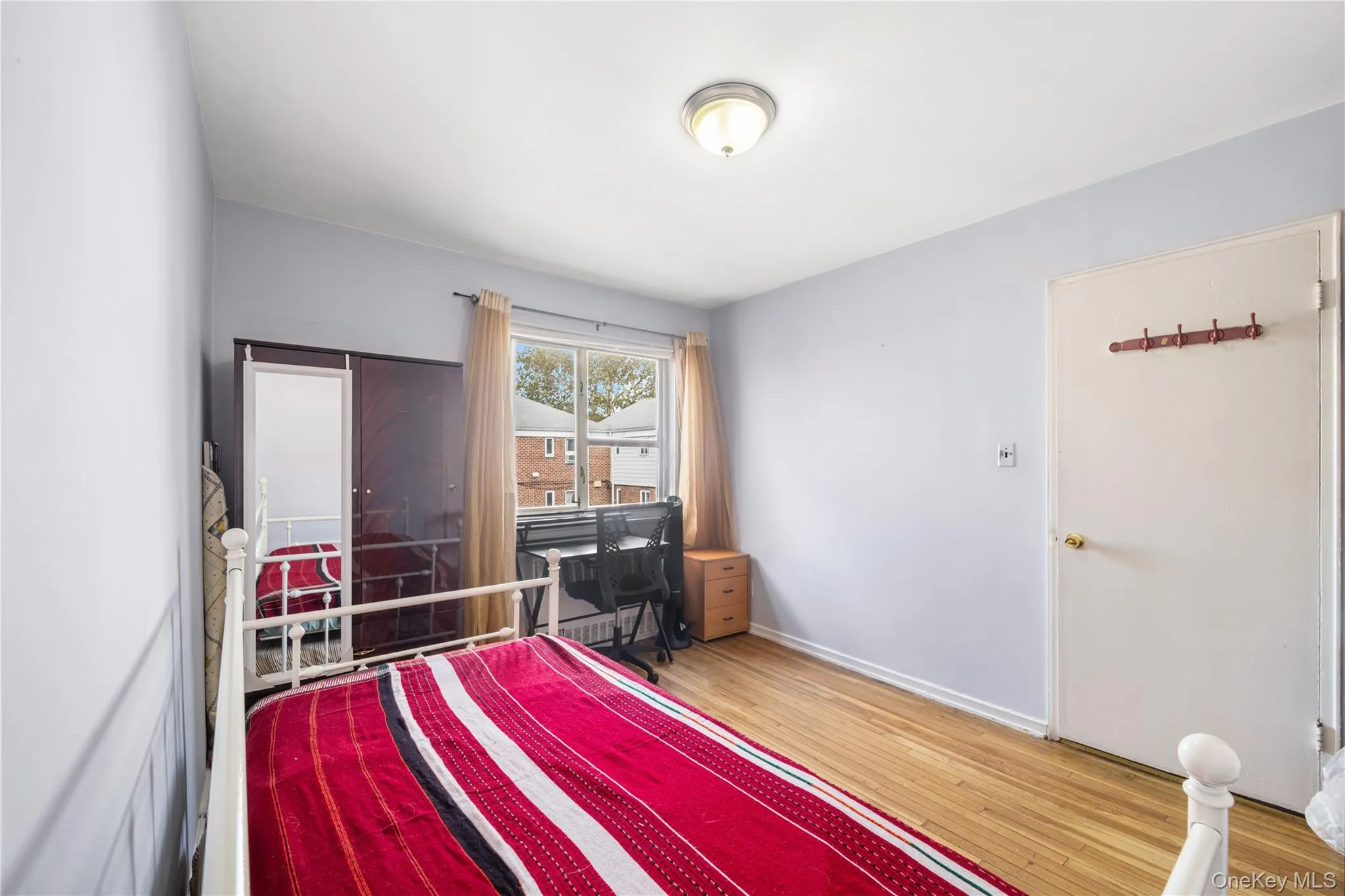 Bedroom featuring light wood-style floors and a desk Bedroom featuring light wood-style floors and a desk