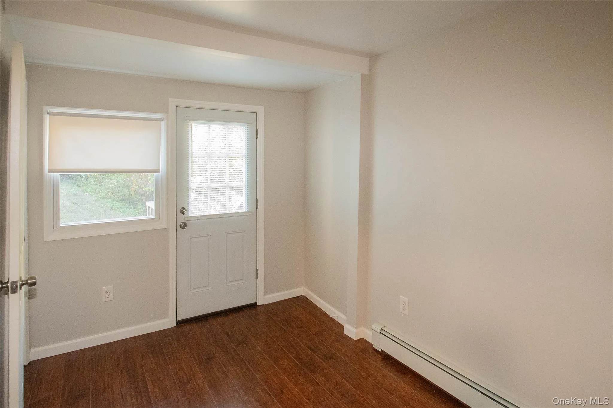 Bedroom from entry looking at the back entry door Bedroom from entry looking at the back entry door