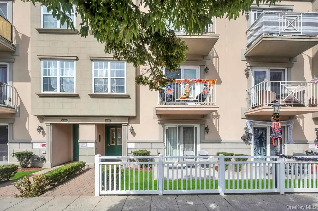 Traditional-style home with a fenced front yard and a balcony Traditional-style home with a fenced front yard and a balcony