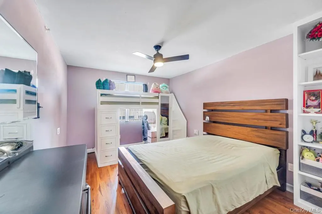 Bedroom with light wood-type flooring and ceiling fan Bedroom with light wood-type flooring and ceiling fan