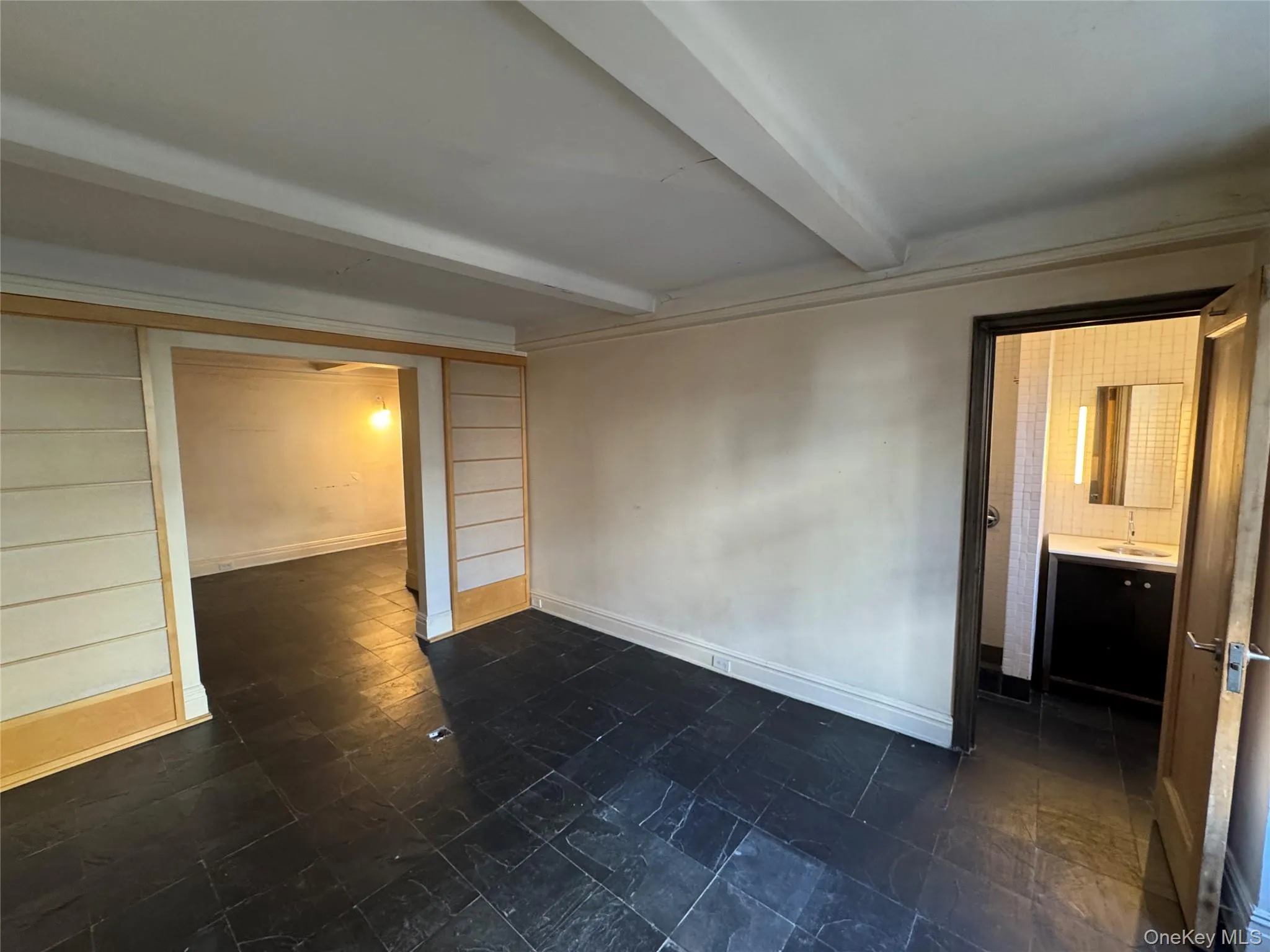 Unfurnished room with beam ceiling and baseboards Unfurnished room with beam ceiling and baseboards