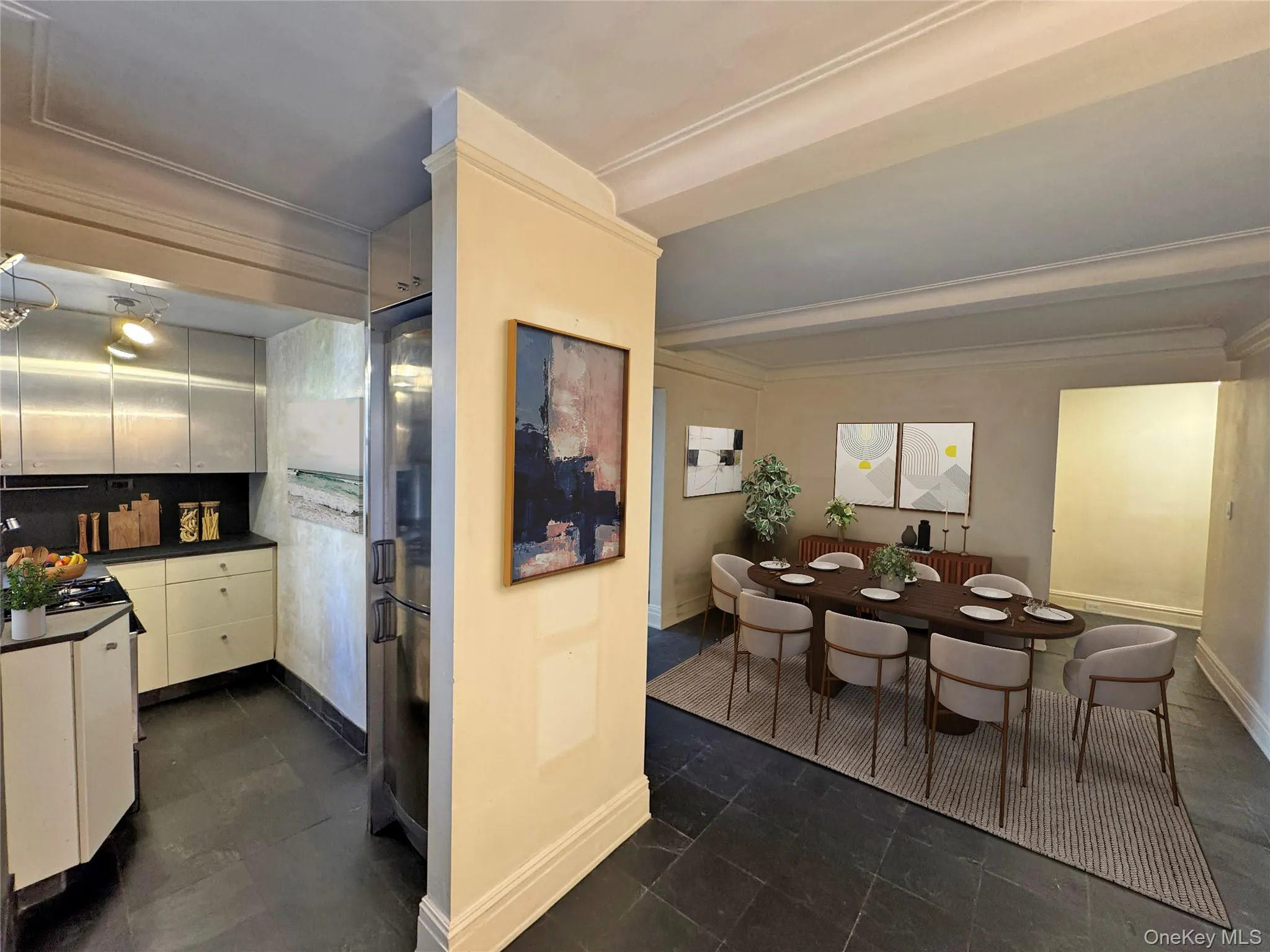 Kitchen with dark countertops, ornamental molding, white cabinets, and stainless steel fridge Kitchen with dark countertops, ornamental molding, white cabinets, and stainless steel fridge
