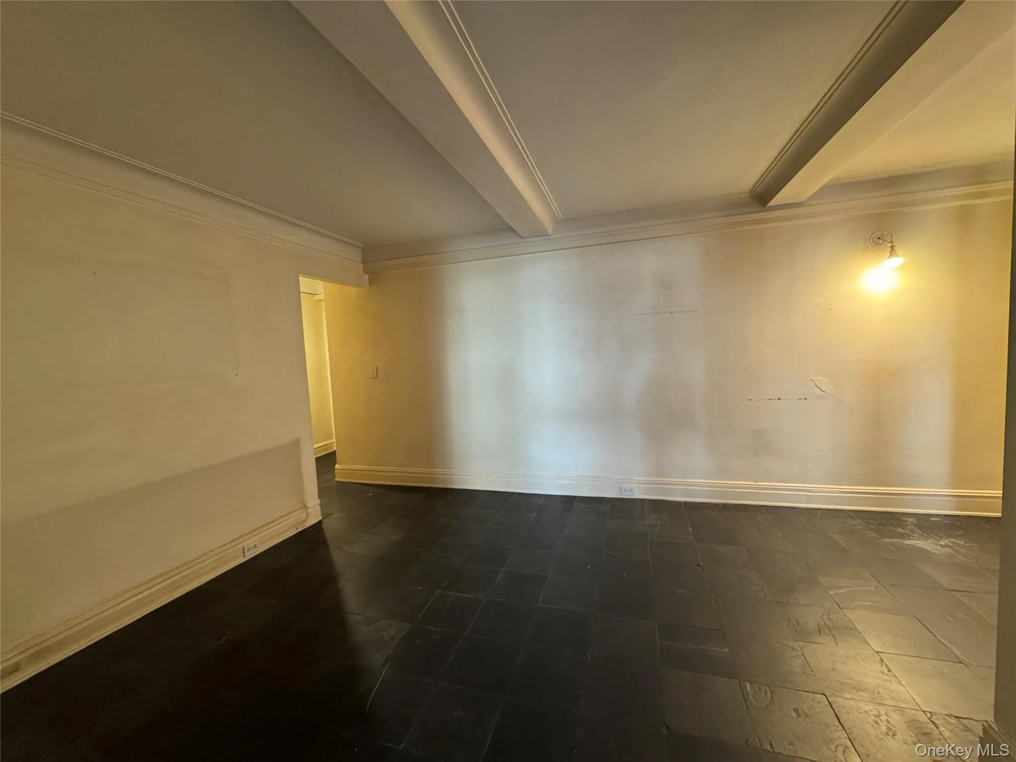 Spare room featuring crown molding and beam ceiling Spare room featuring crown molding and beam ceiling