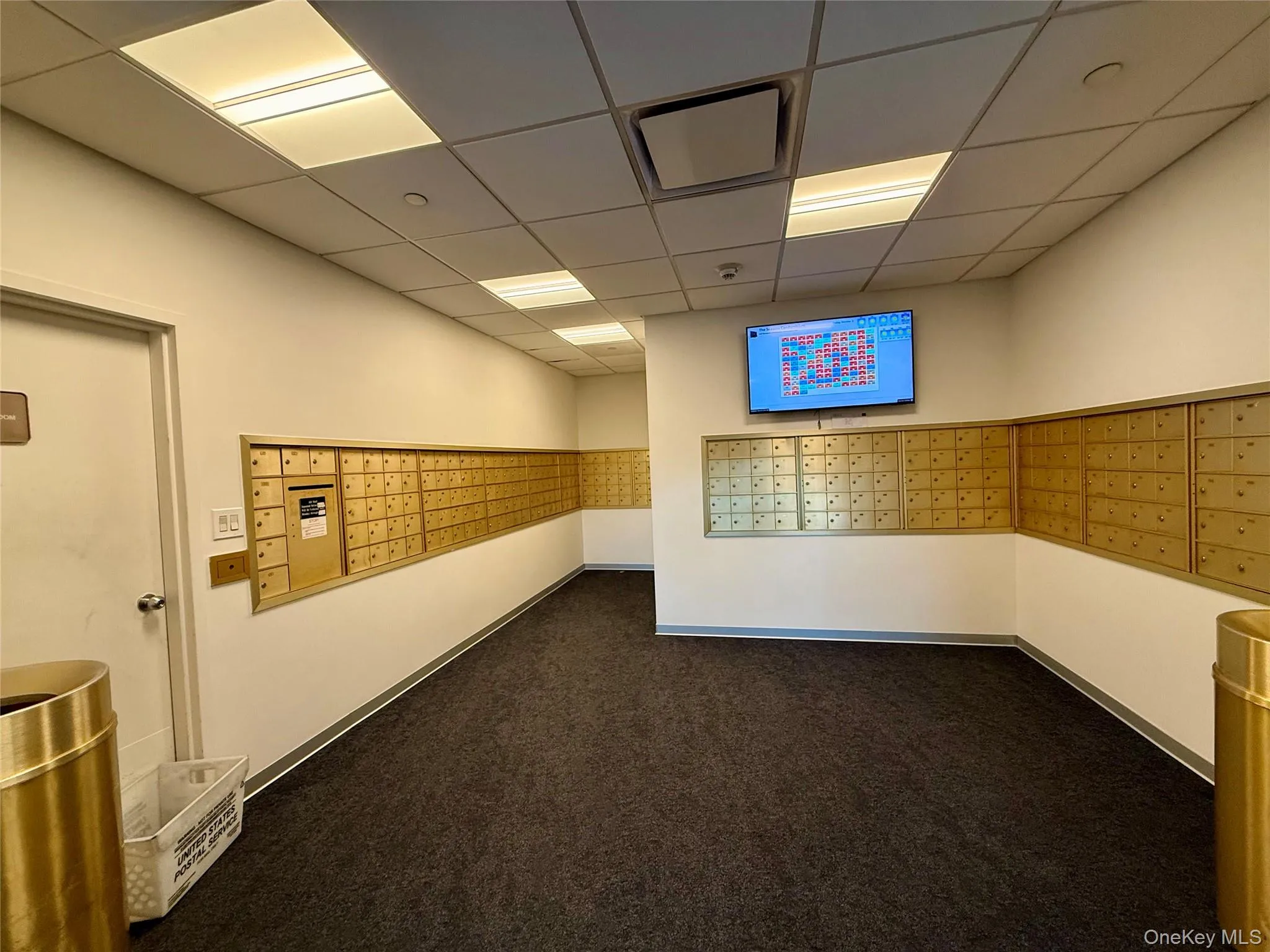 View of property's community with a paneled ceiling and mail area View of property's community with a paneled ceiling and mail area