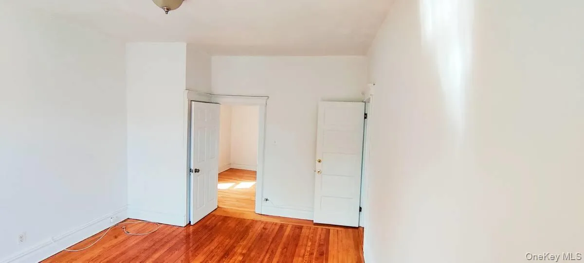 Unfurnished bedroom featuring light wood-style floors and baseboards Unfurnished bedroom featuring light wood-style floors and baseboards
