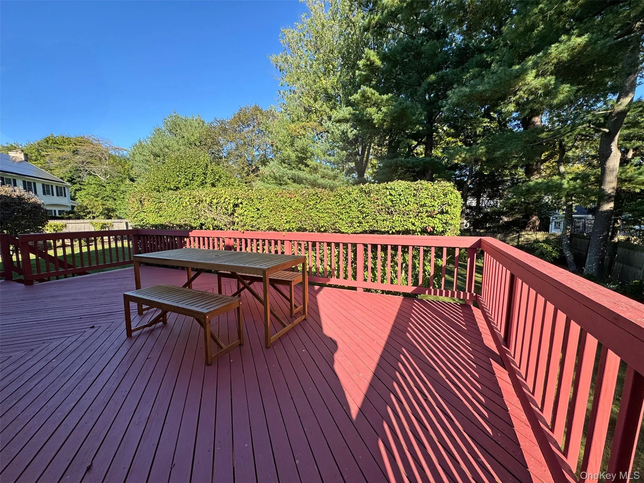 Deck with outdoor dining space and view of scattered trees Deck with outdoor dining space and view of scattered trees