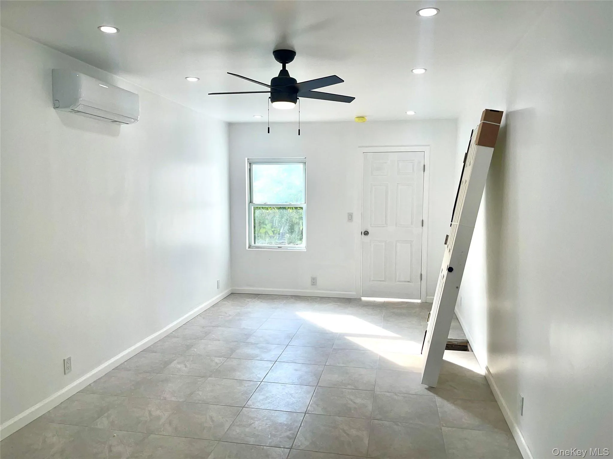 Living or dinning room featuring a wall mounted AC, recessed lighting, and a ceiling fan Living or dinning room featuring a wall mounted AC, recessed lighting, and a ceiling fan