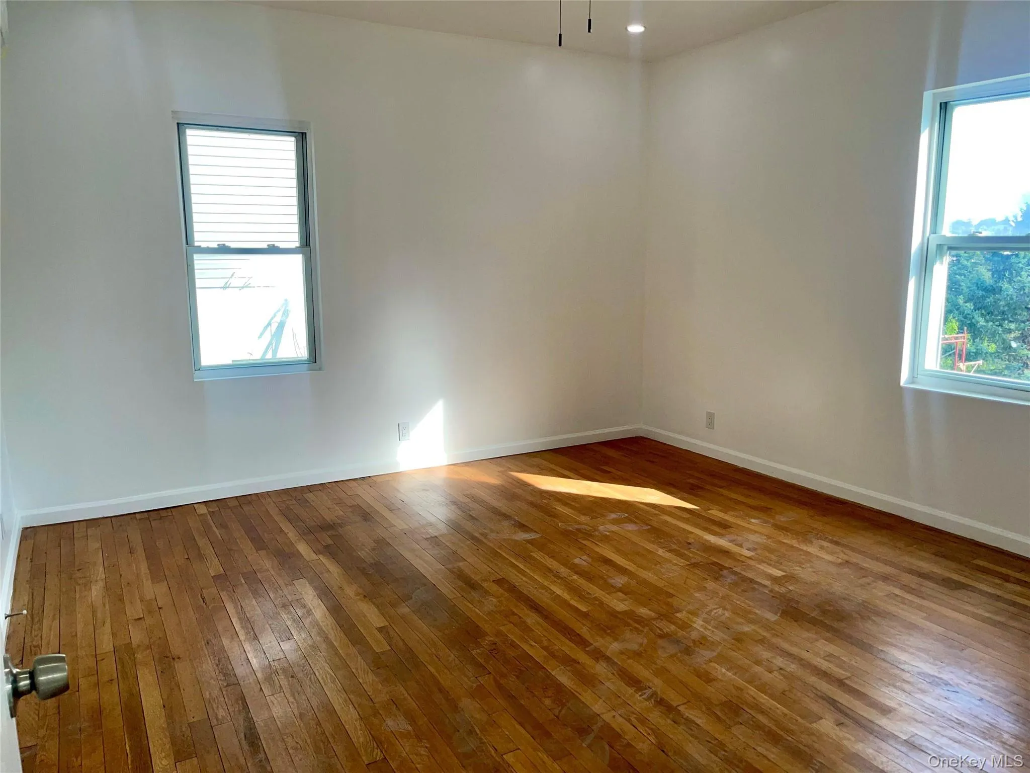 Unfurnished room featuring hardwood / wood-style flooring and recessed lighting Unfurnished room featuring hardwood / wood-style flooring and recessed lighting