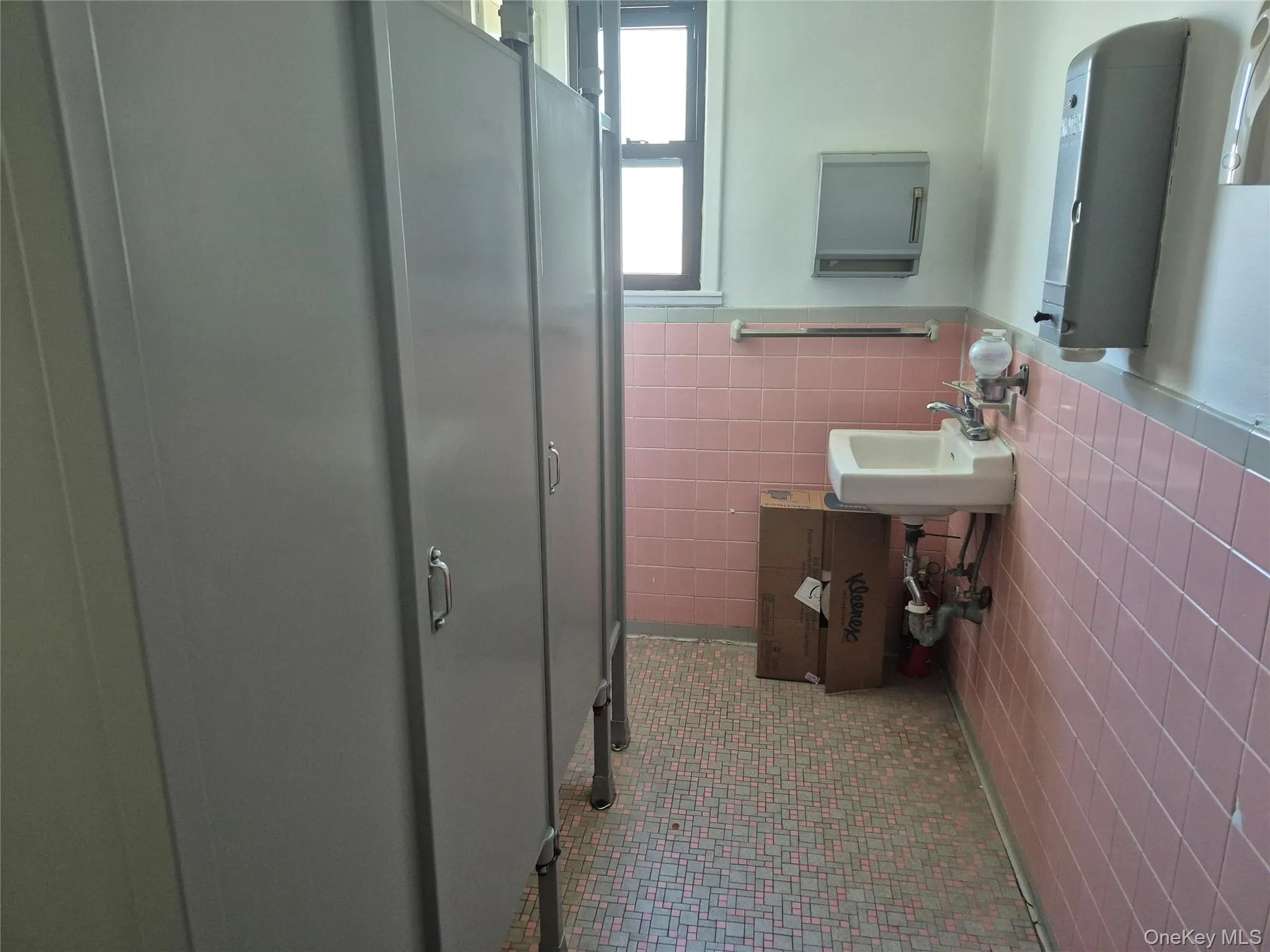 Bathroom featuring tile walls, wainscoting, and light tile patterned floors Bathroom featuring tile walls, wainscoting, and light tile patterned floors