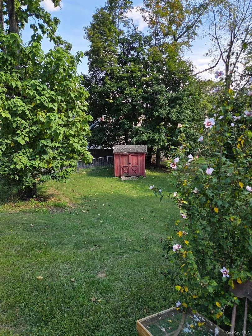 View of fenced in yard with a storage shed. View of fenced in yard with a storage shed.