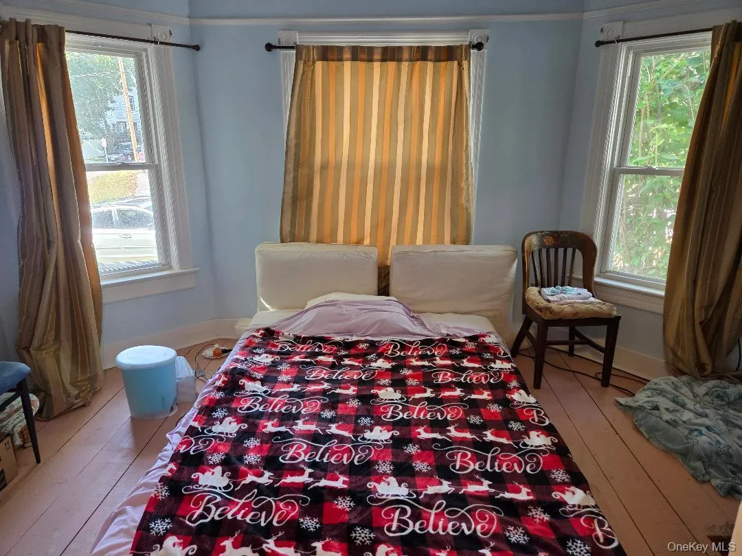 Bedroom featuring hardwood / wood-style floors and baseboards Bedroom featuring hardwood / wood-style floors and baseboards