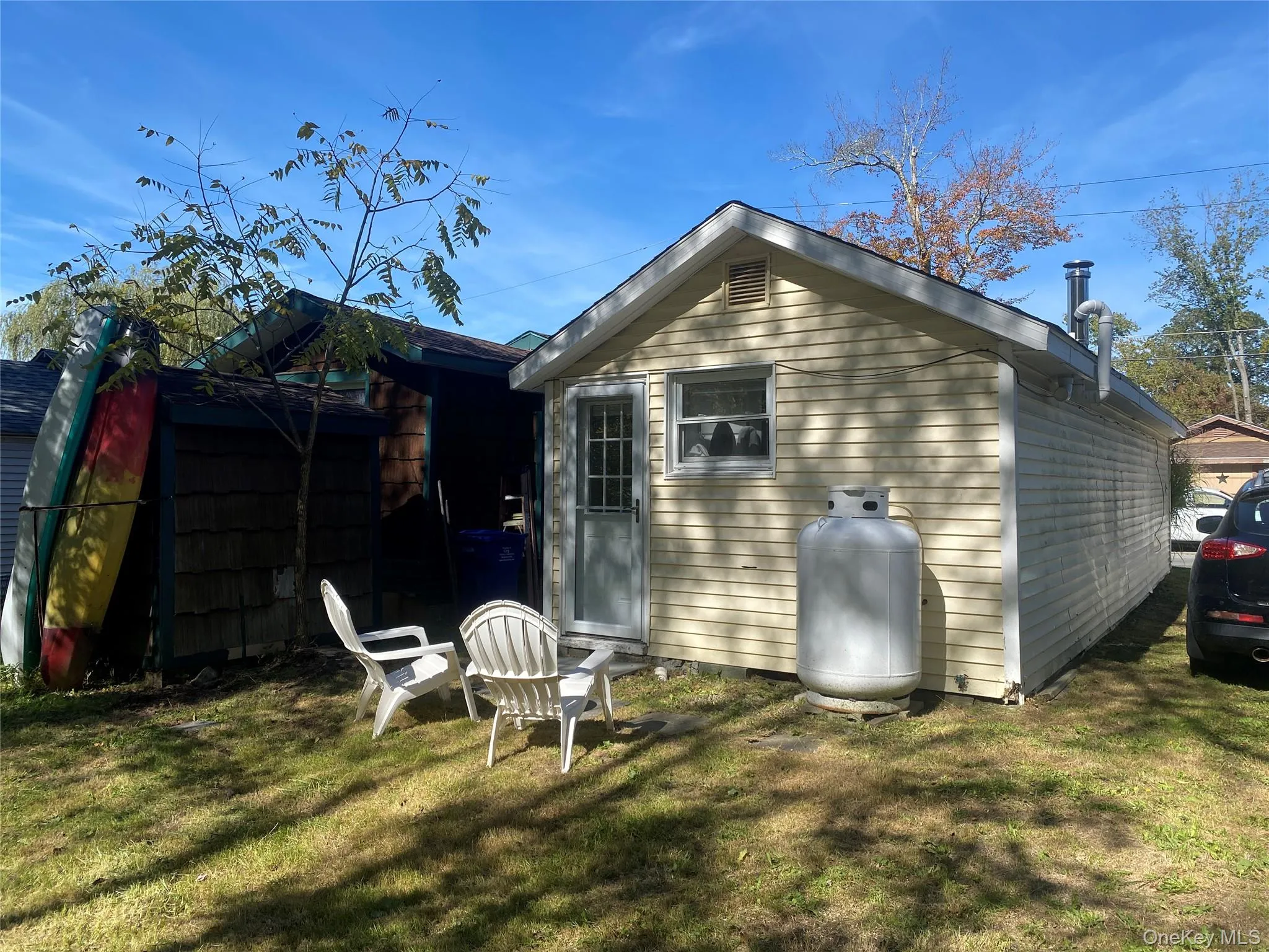 Rear view of house featuring a lawn Rear view of house featuring a lawn