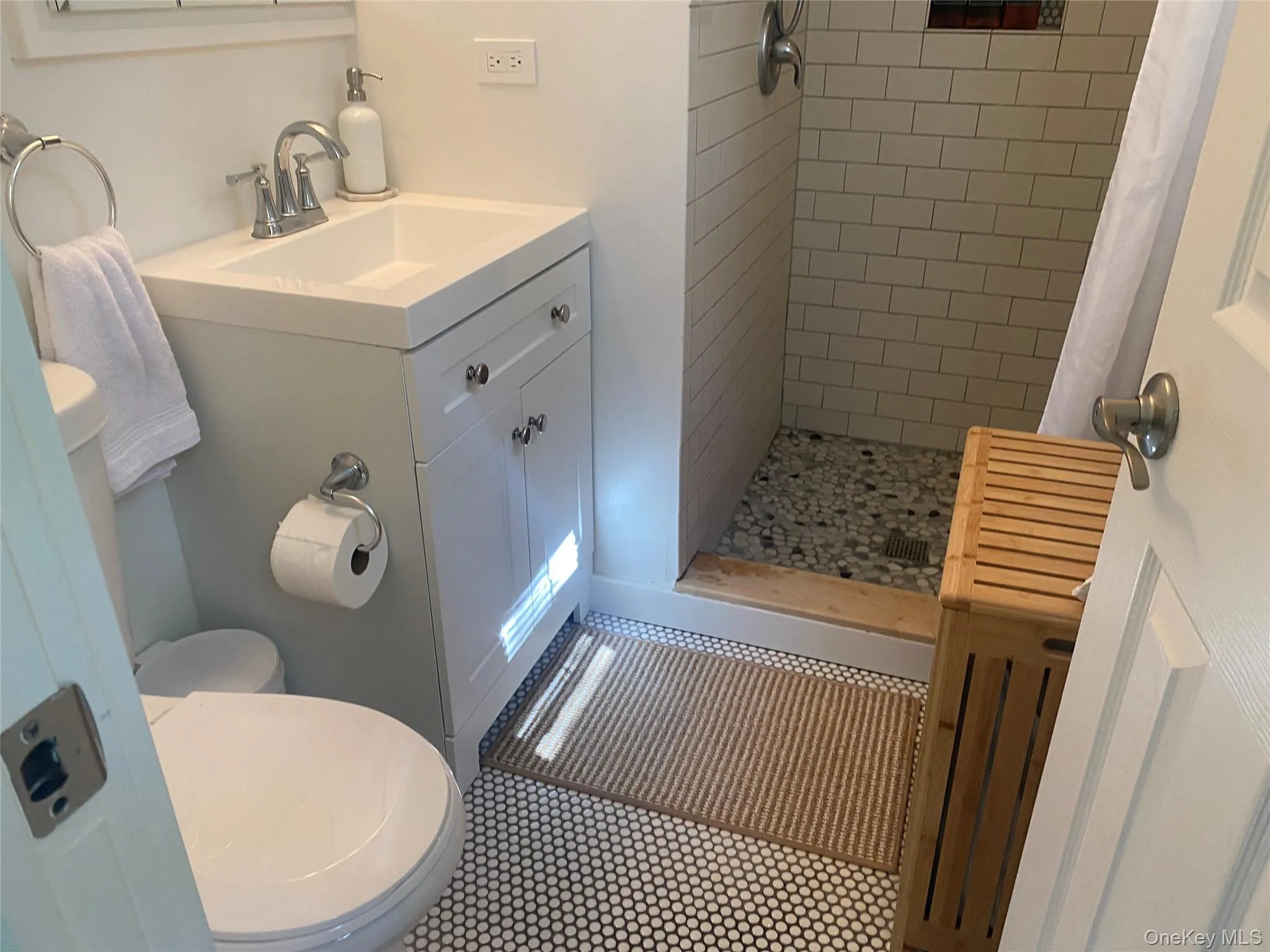 Full bathroom with a stall shower and vanity Full bathroom with a stall shower and vanity