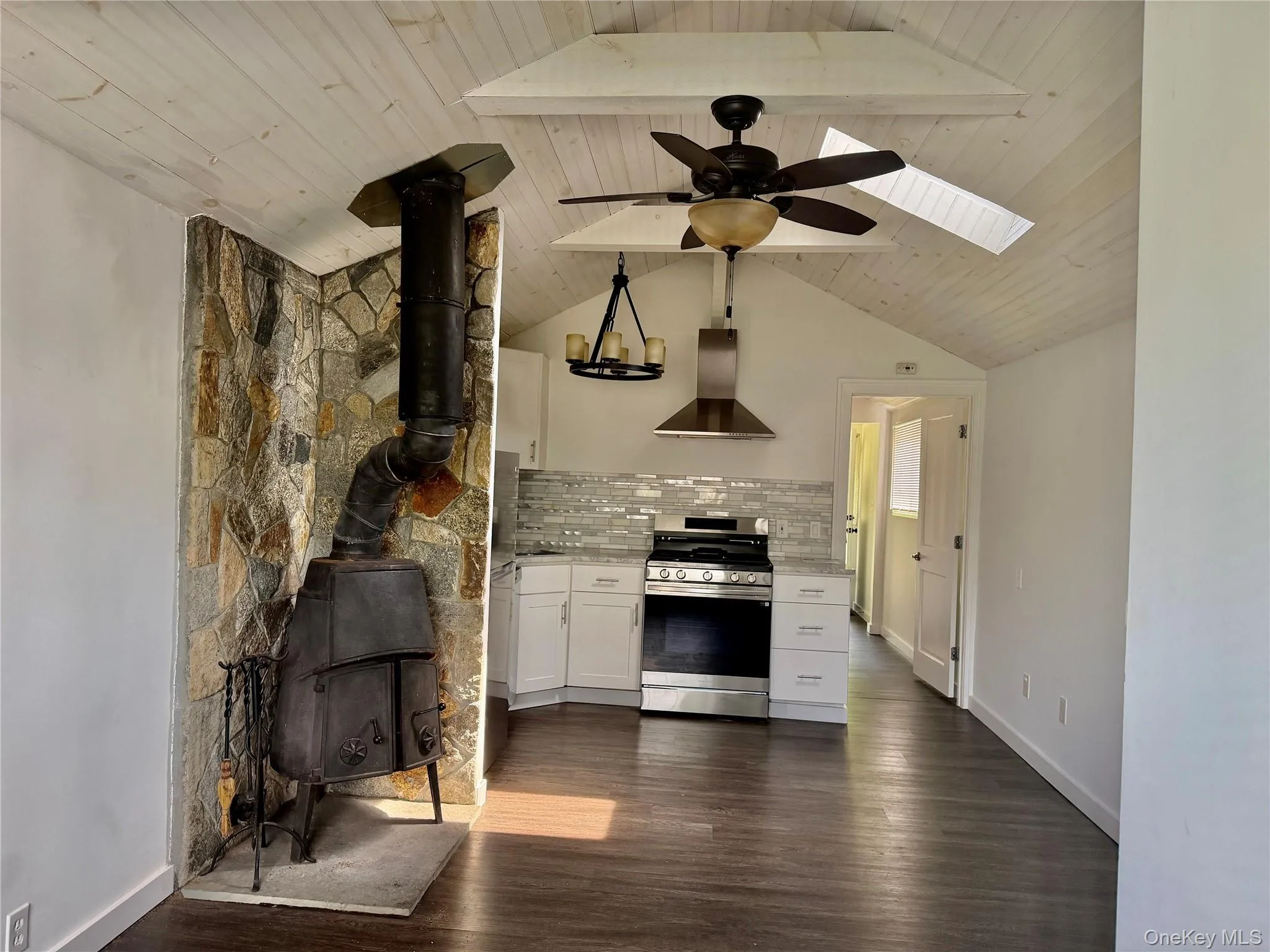 Beamed Cathedral ceiling with skylight, & wood stove fireplace. Beamed Cathedral ceiling with skylight, & wood stove fireplace.