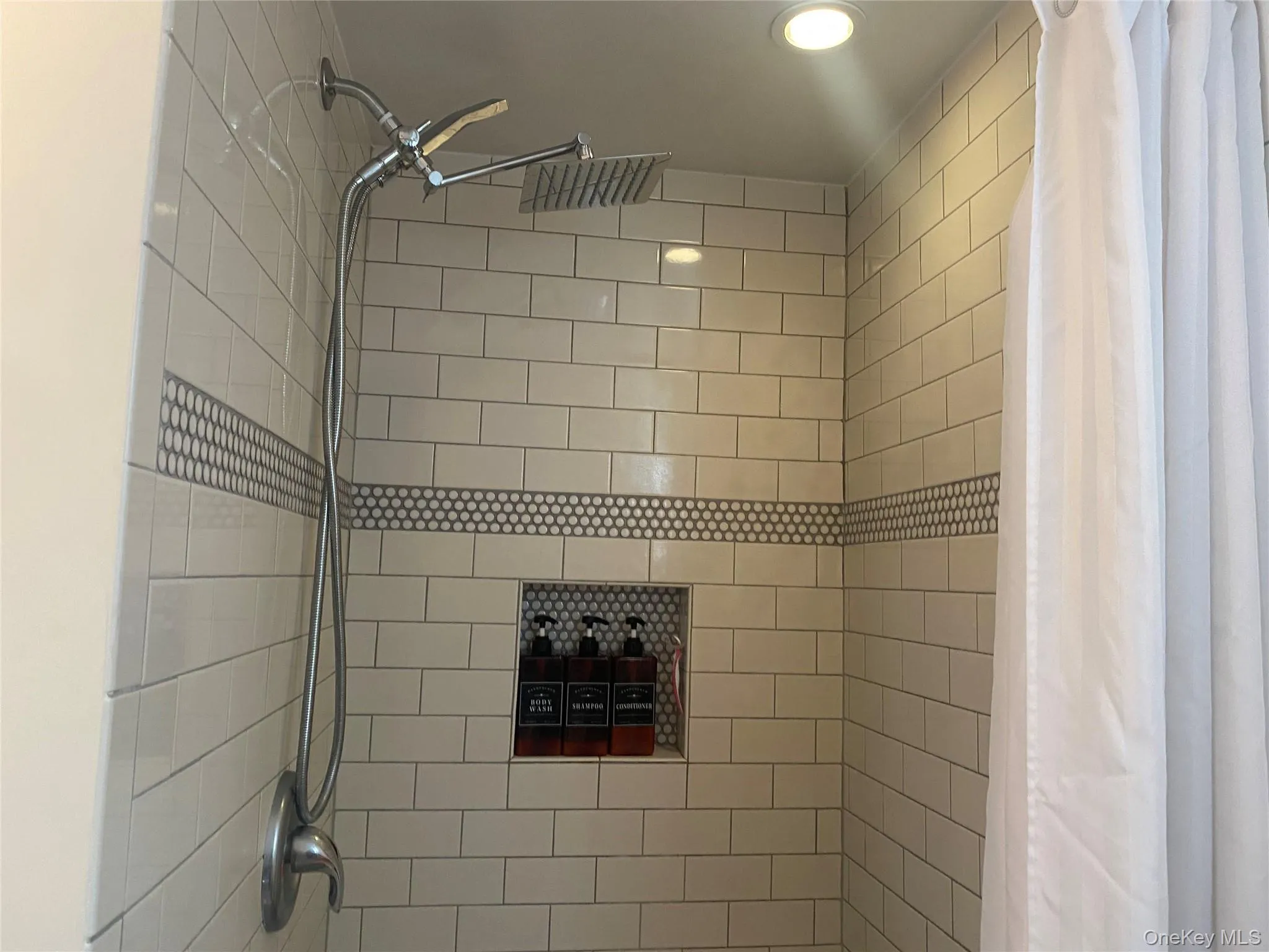 Bathroom with tiled shower and recessed lighting Bathroom with tiled shower and recessed lighting