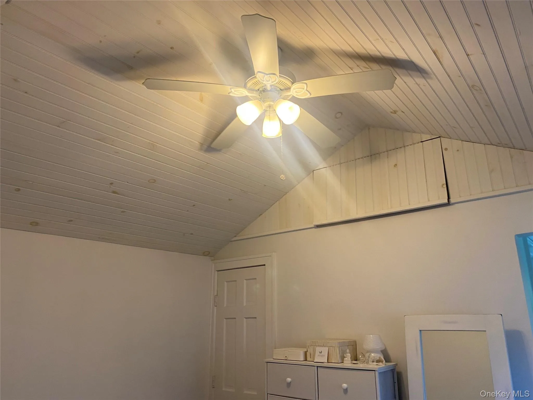 Bedroom white washed tongue & groove pine ceiling and ceiling fan. Bedroom white washed tongue & groove pine ceiling and ceiling fan.