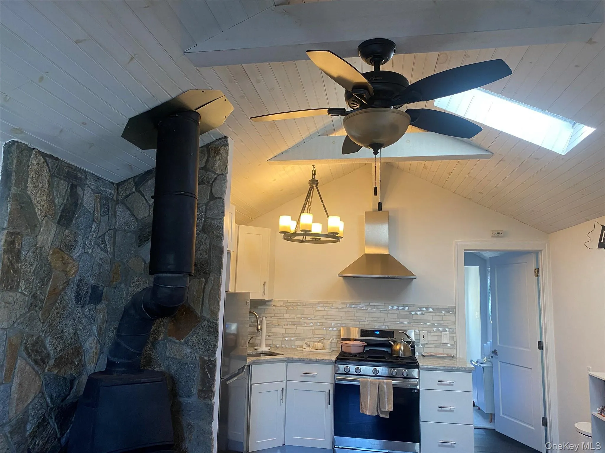 Kitchen featuring beamed vaulted ceiling, skylight, ceiling fan Kitchen featuring beamed vaulted ceiling, skylight, ceiling fan