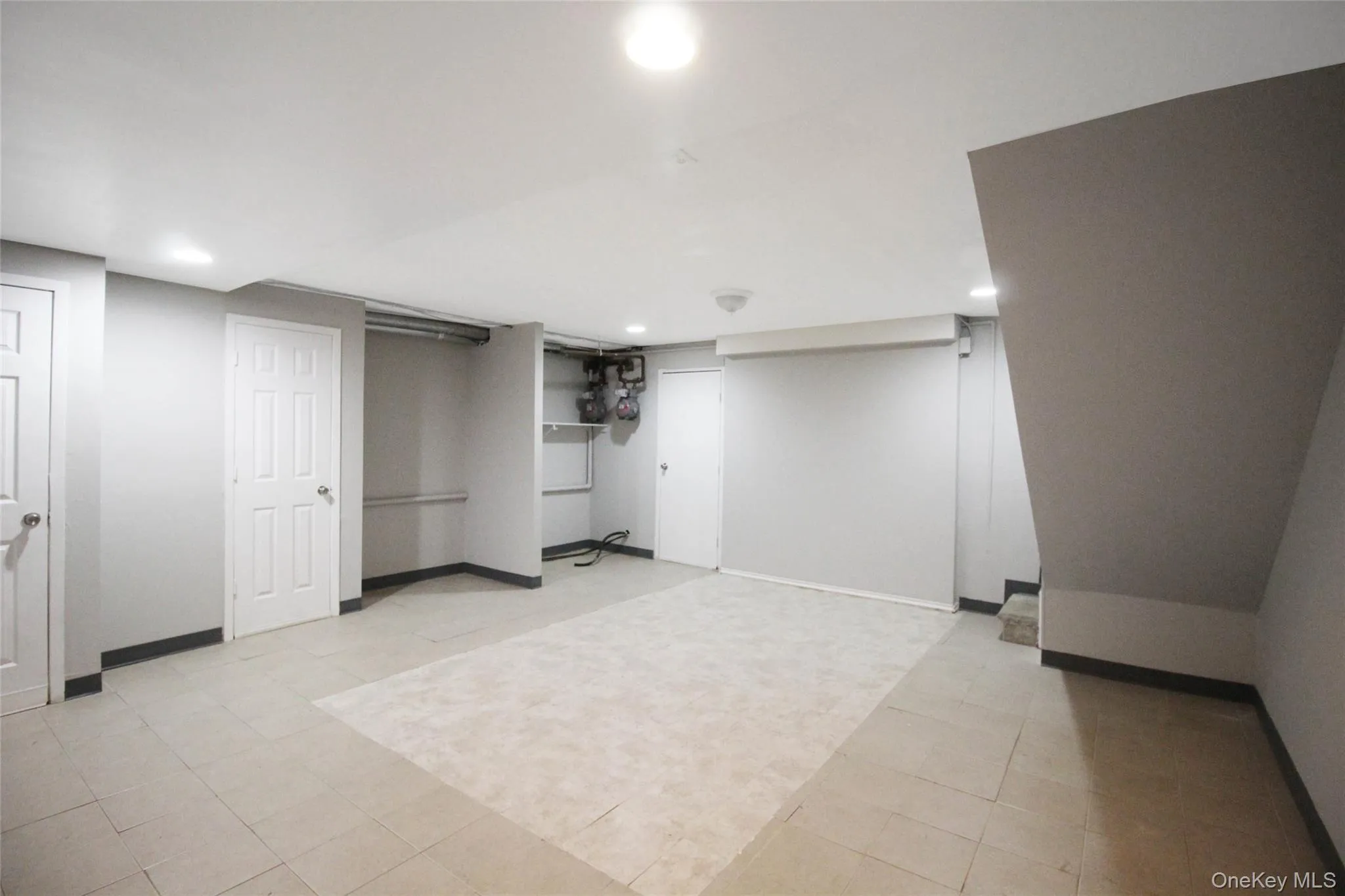 Finished below grade area with recessed lighting and light tile patterned floors Finished below grade area with recessed lighting and light tile patterned floors