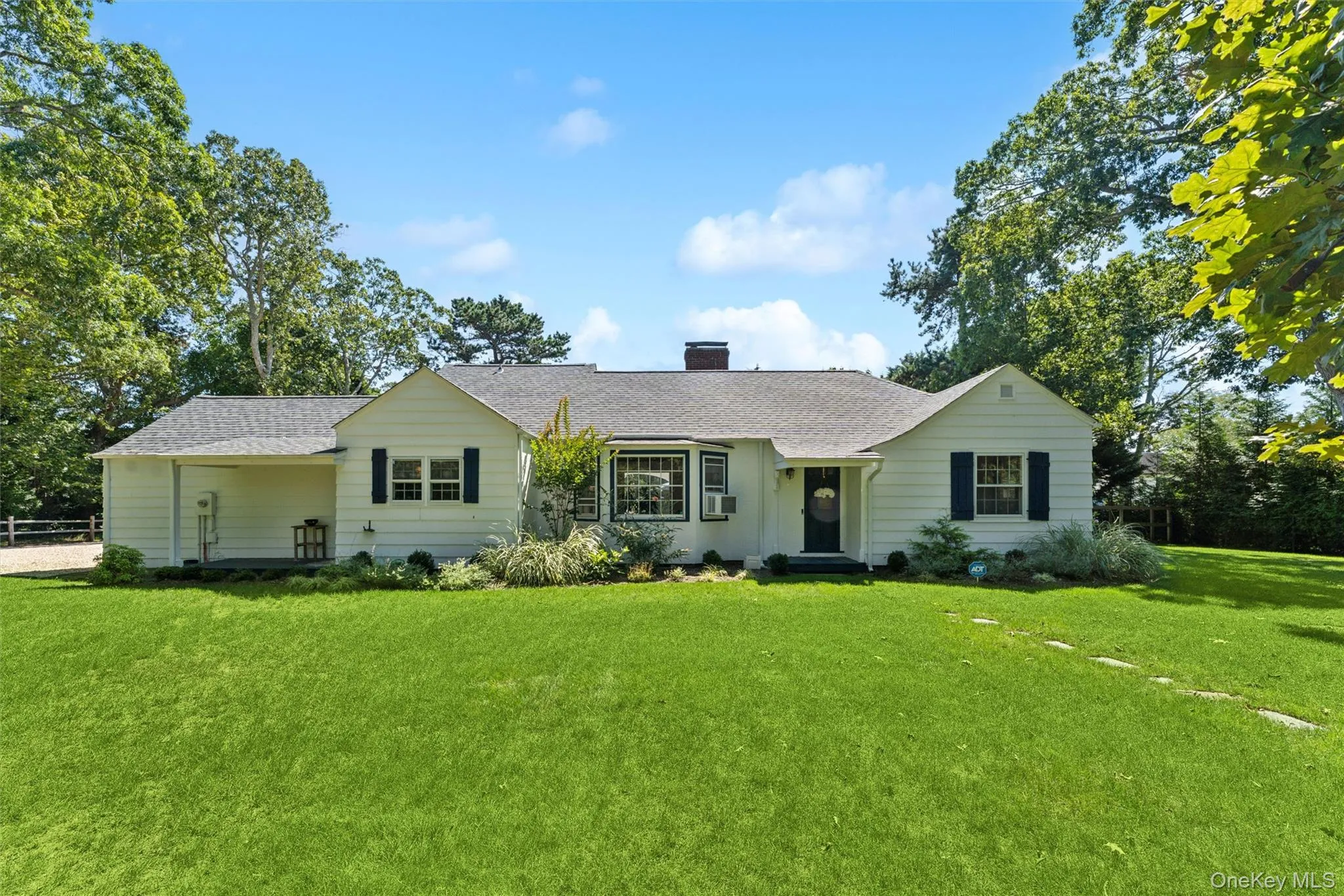 Ranch-style home with a front yard, roof with shingles, a chimney, and cooling unit Ranch-style home with a front yard, roof with shingles, a chimney, and cooling unit
