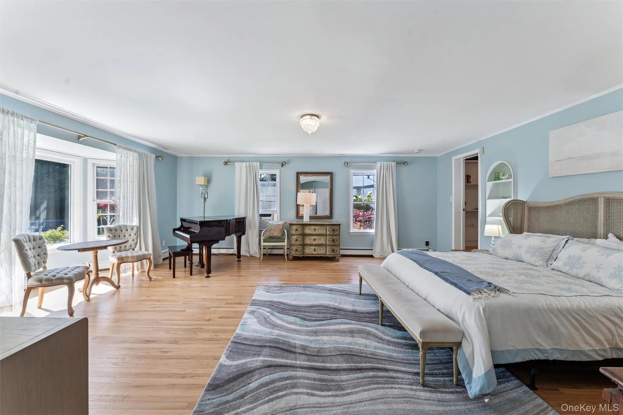 Bedroom with light wood-style flooring and crown molding Bedroom with light wood-style flooring and crown molding