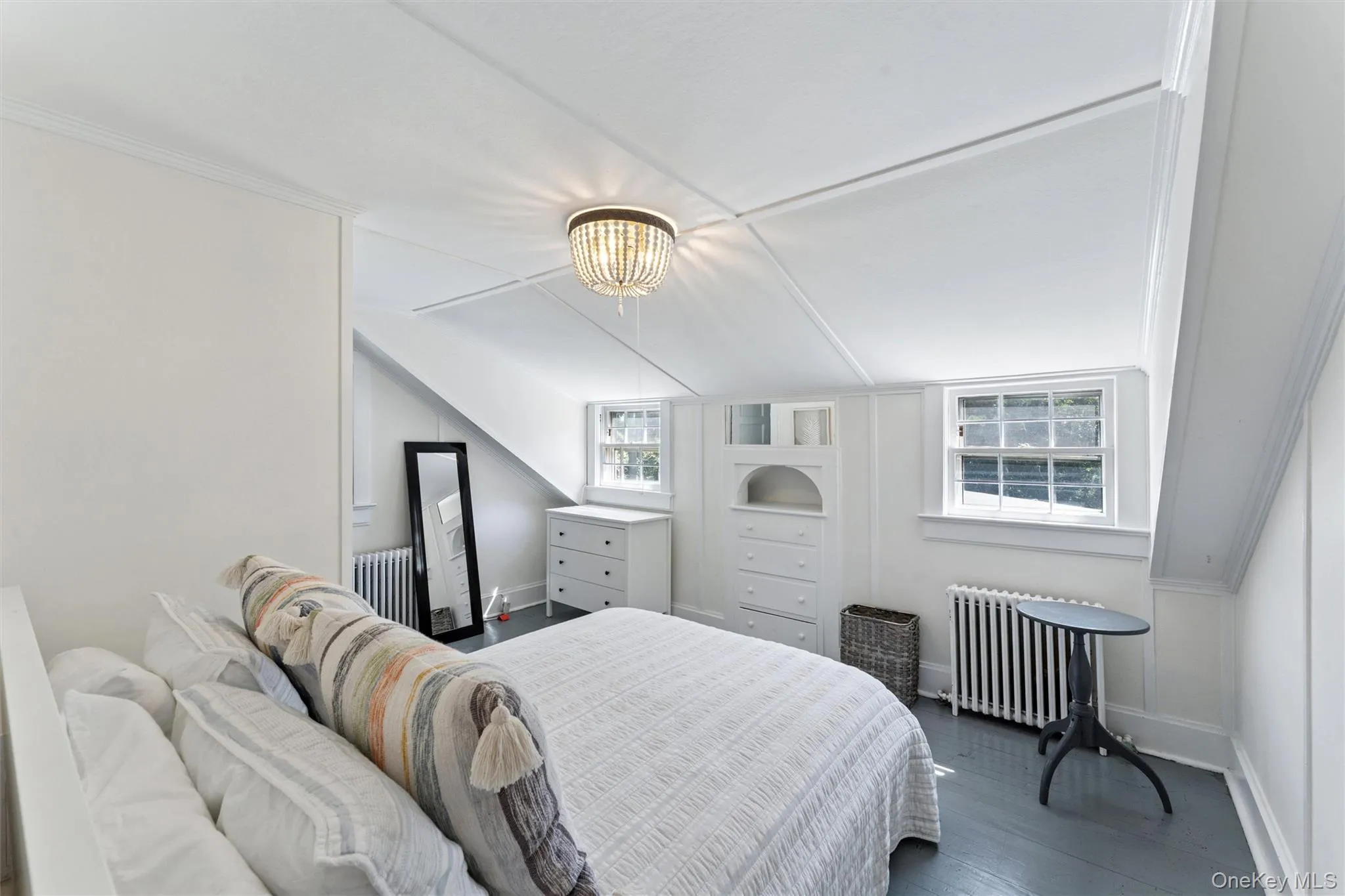 Bedroom featuring wood finished floors and radiator heating unit Bedroom featuring wood finished floors and radiator heating unit