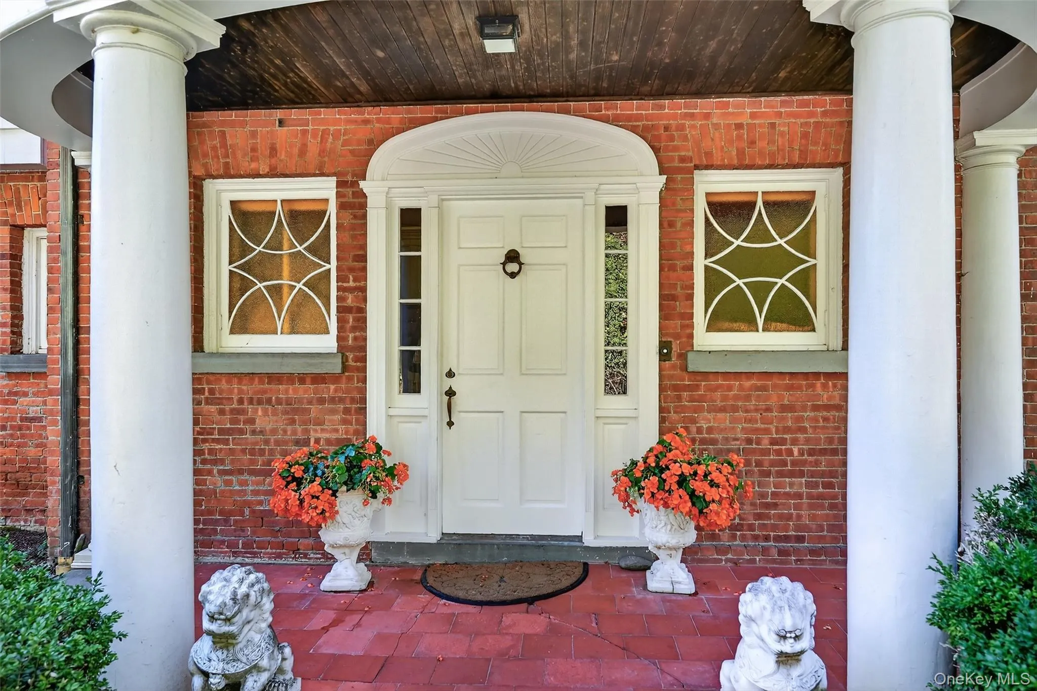 Front door under the covered, columned portico. Front door under the covered, columned portico.