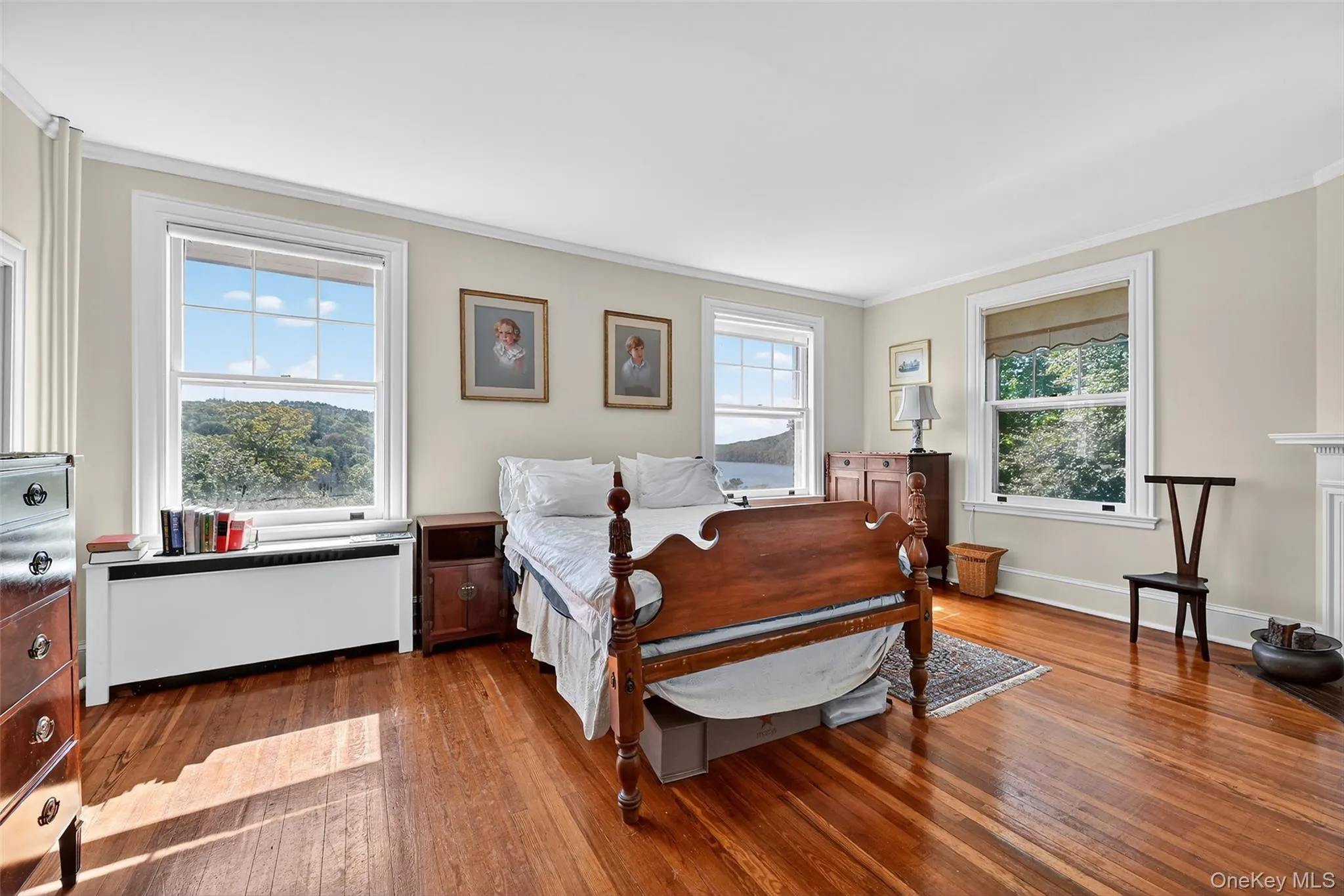 Primary bedroom has scenic lake views, hardwood floors, wood burning fireplace, dressing room, walk-in-closet, and en-suite bath. Primary bedroom has scenic lake views, hardwood floors, wood burning fireplace, dressing room, walk-in-closet, and en-suite bath.
