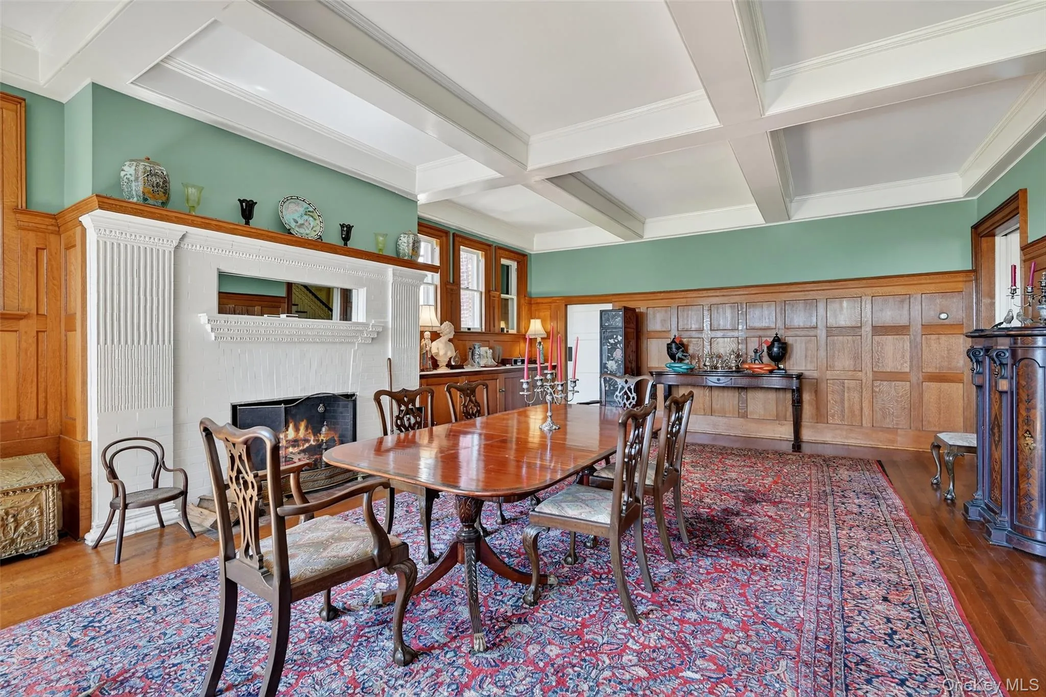Dining room boasts wood burning fireplace, abundant natural light from the South and West, and features restored wood paneling. Dining room boasts wood burning fireplace, abundant natural light from the South and West, and features restored wood paneling.